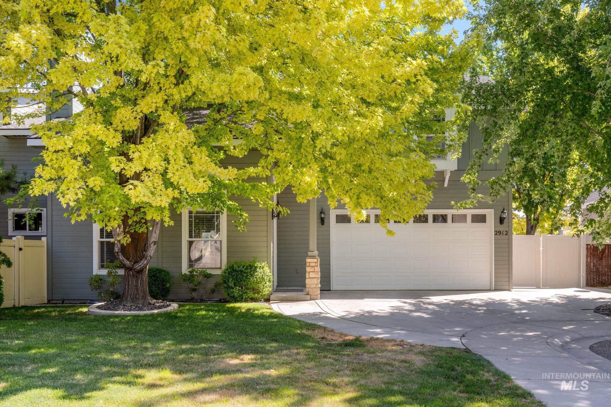 Obstructed view of property featuring a garage and concrete driveway