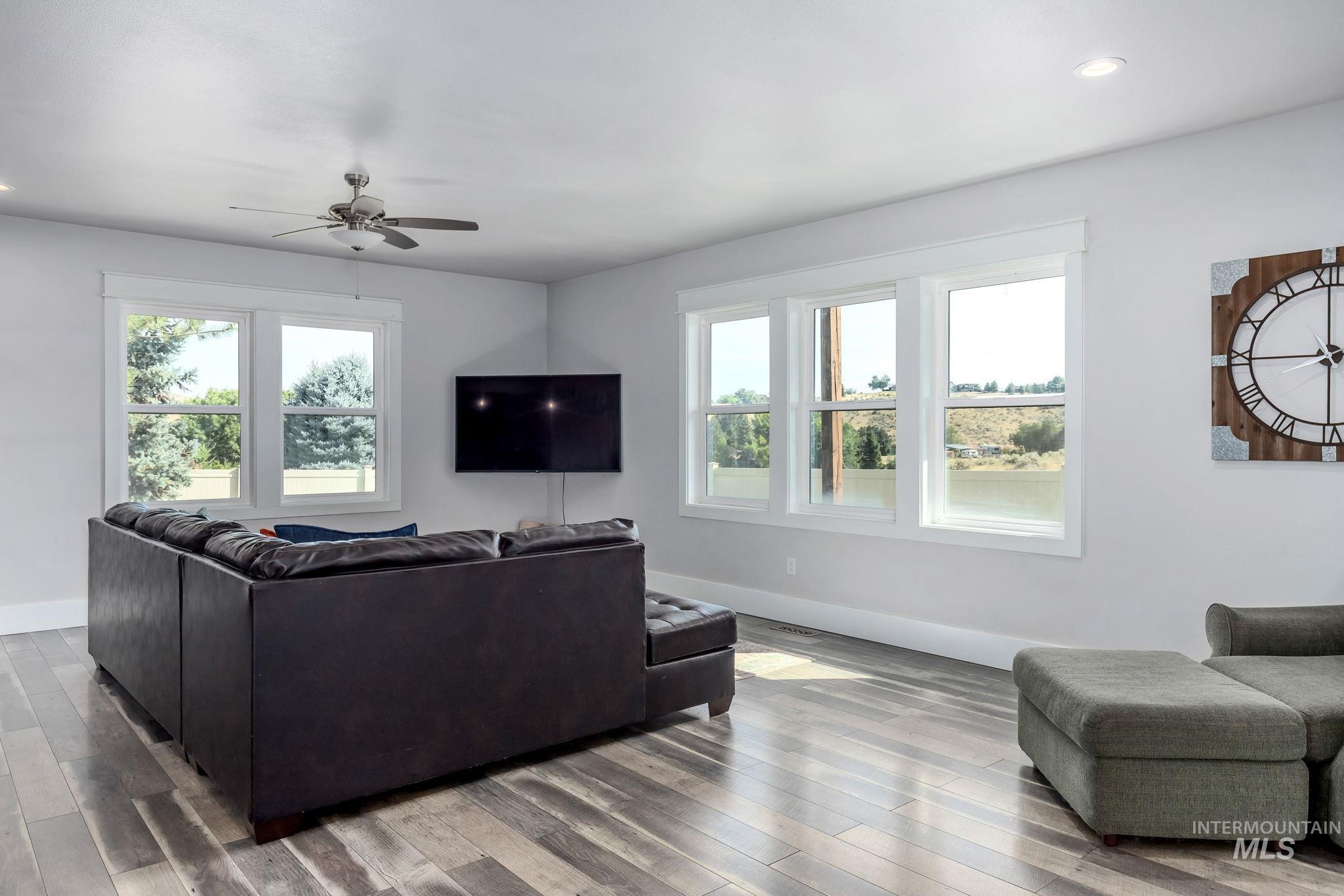 Living room featuring recessed lighting, wood finished floors, and a ceiling fan