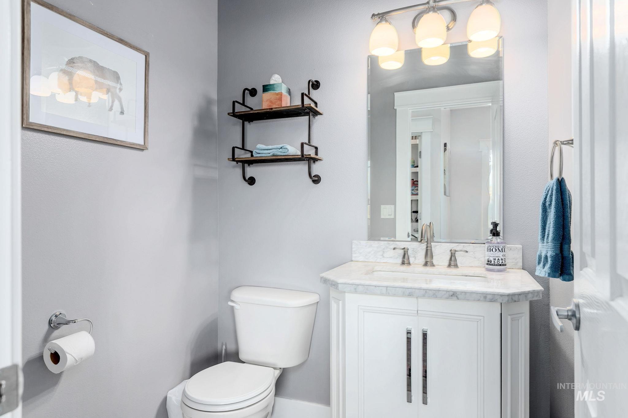 Half bath featuring toilet and vanity