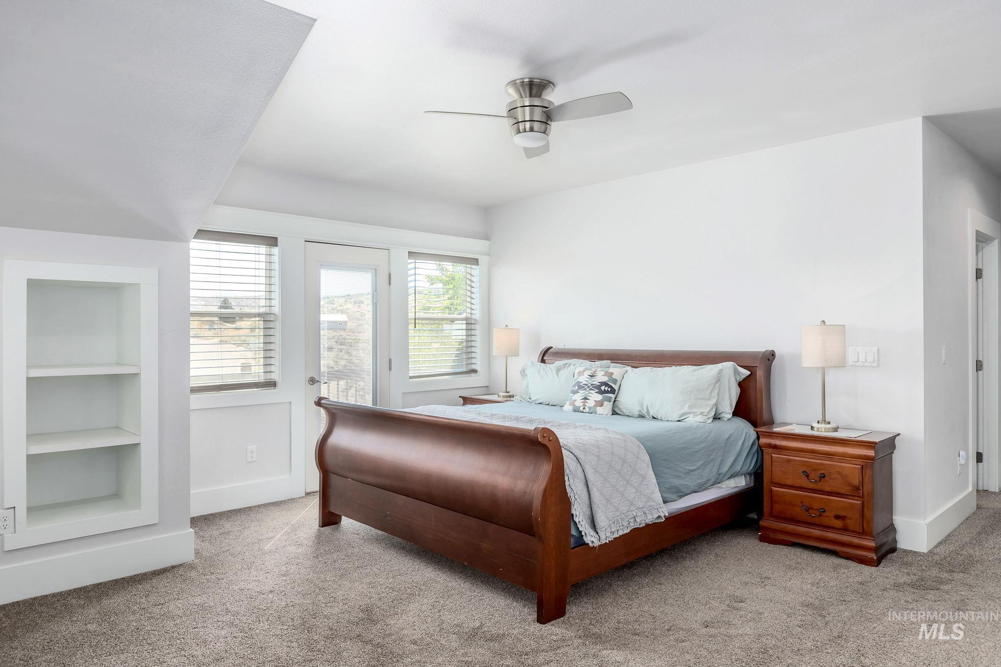 Bedroom featuring access to exterior, carpet floors, and ceiling fan