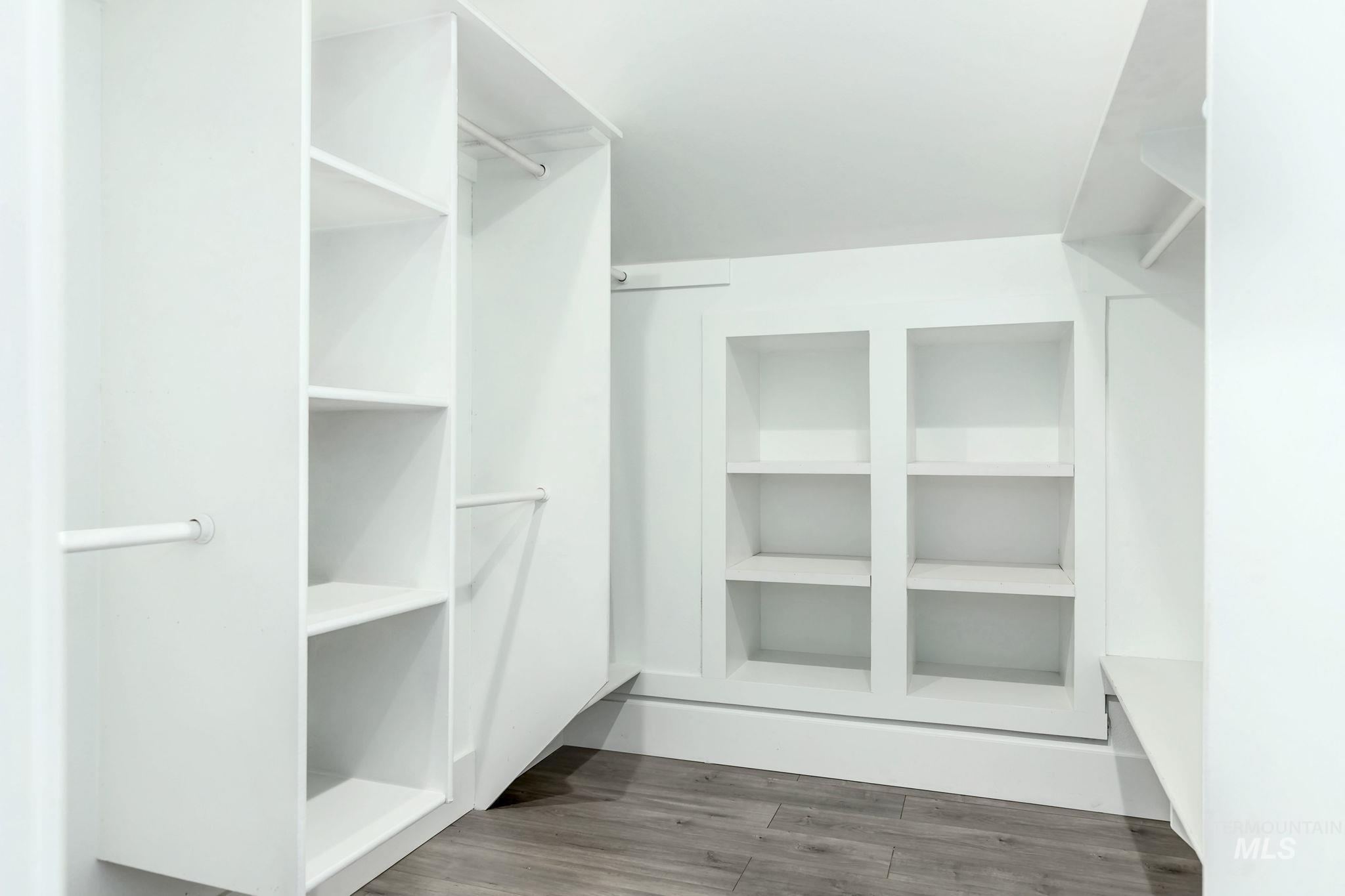 Walk in closet featuring wood finished floors
