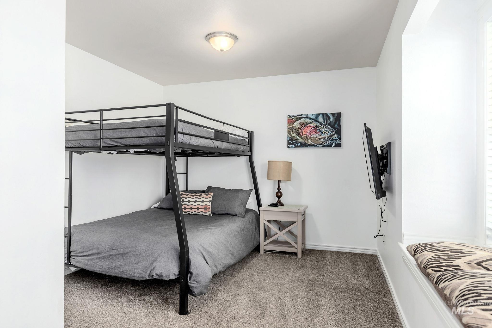 Carpeted bedroom with baseboards