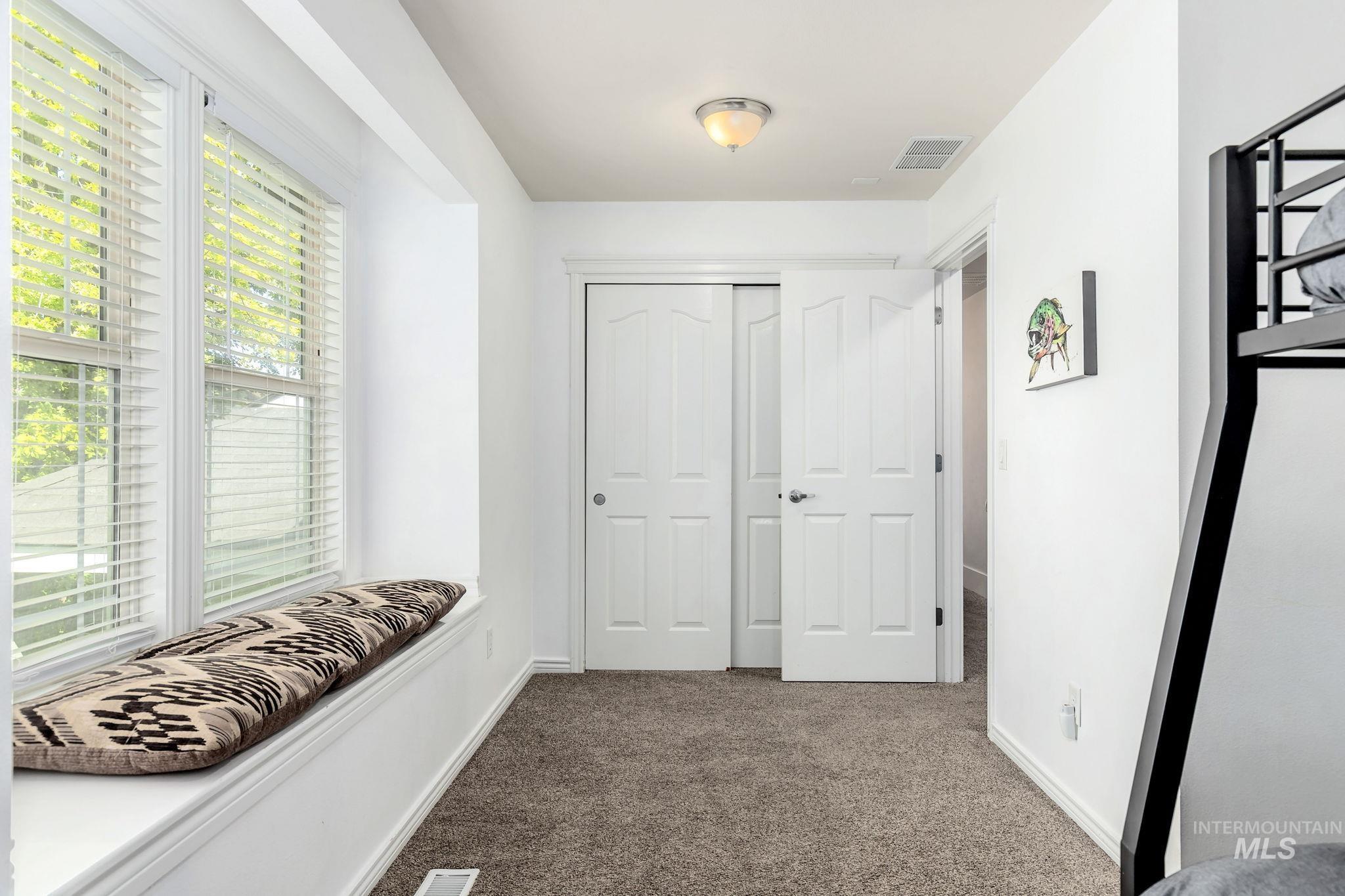 Hall featuring carpet floors and baseboards