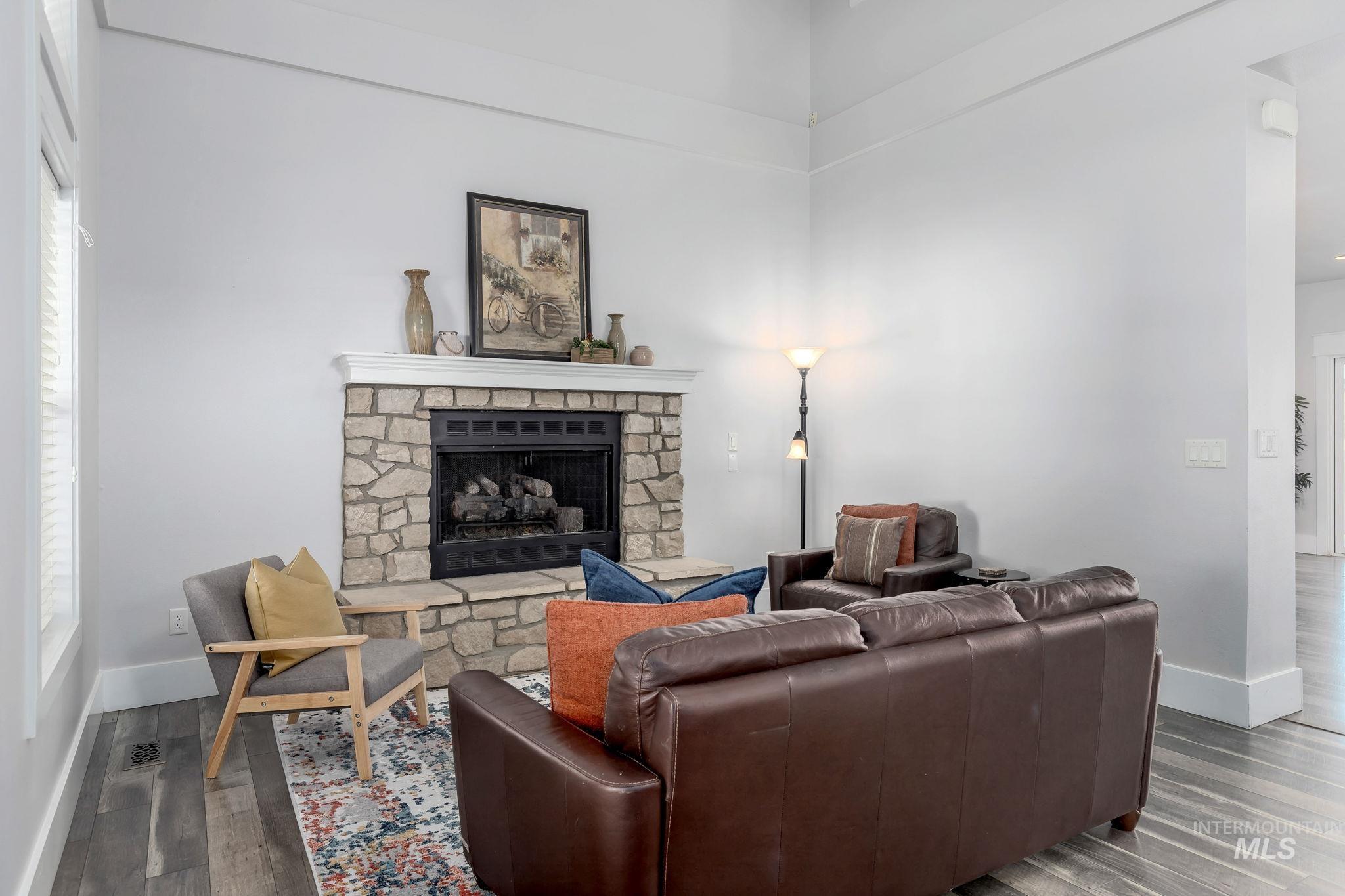 Living room with a fireplace and wood finished floors