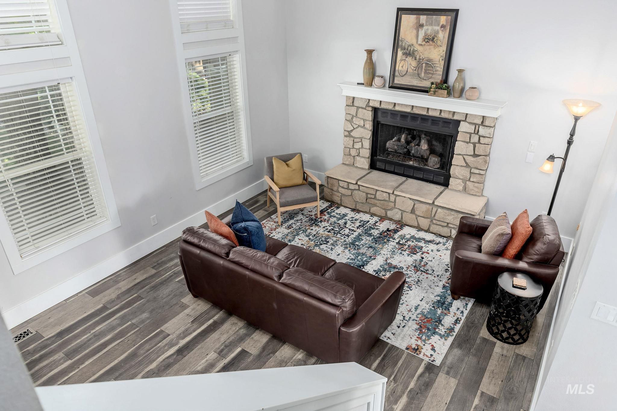 Living area featuring a fireplace and wood finished floors