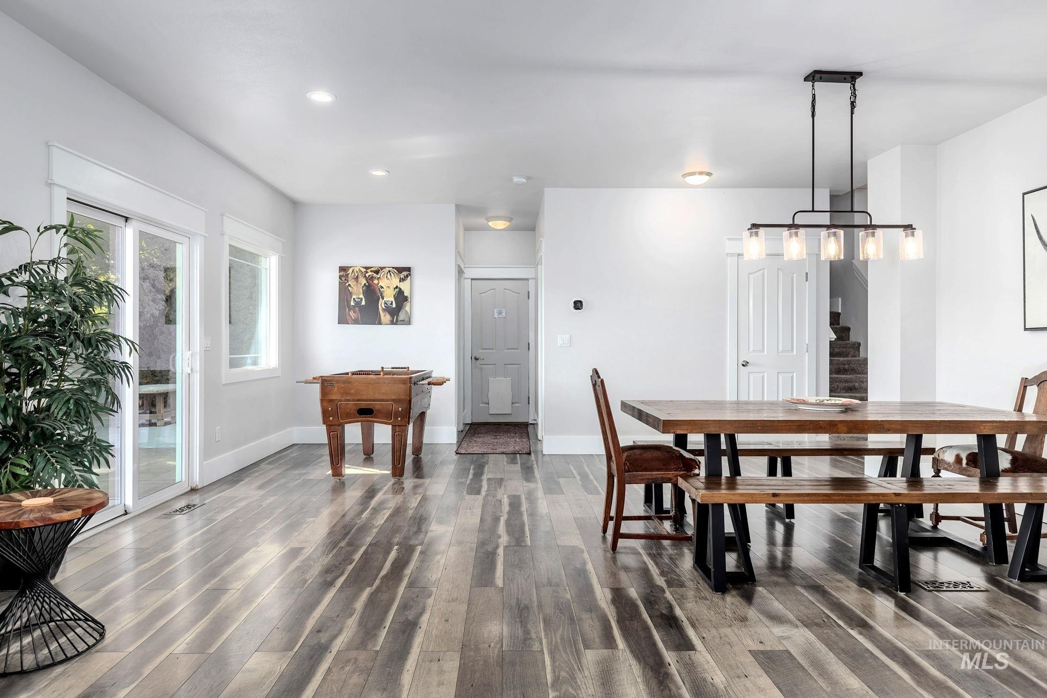 Dining area with stairs, dark wood-type flooring, and recessed lighting