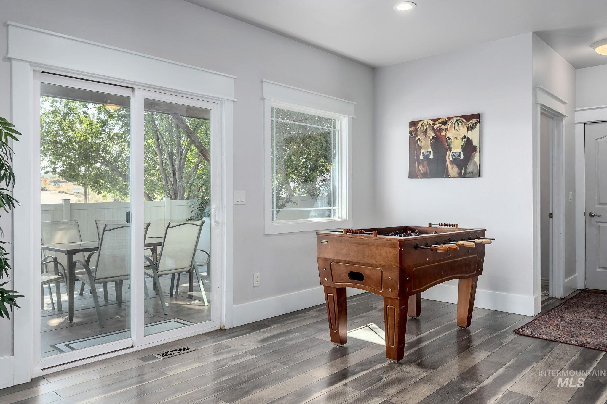 Recreation room featuring wood finished floors and recessed lighting