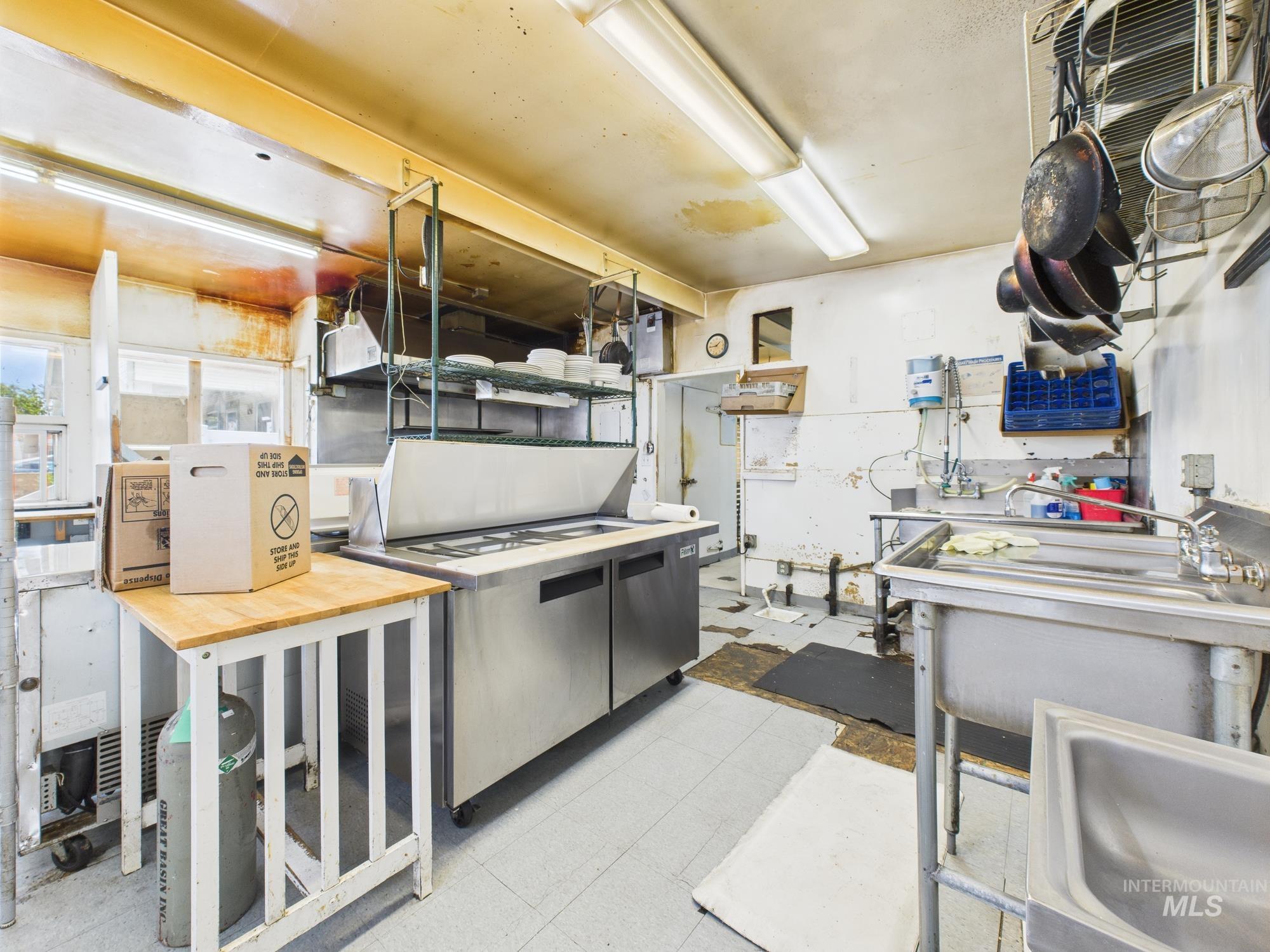Kitchen with tile patterned floors and a sink