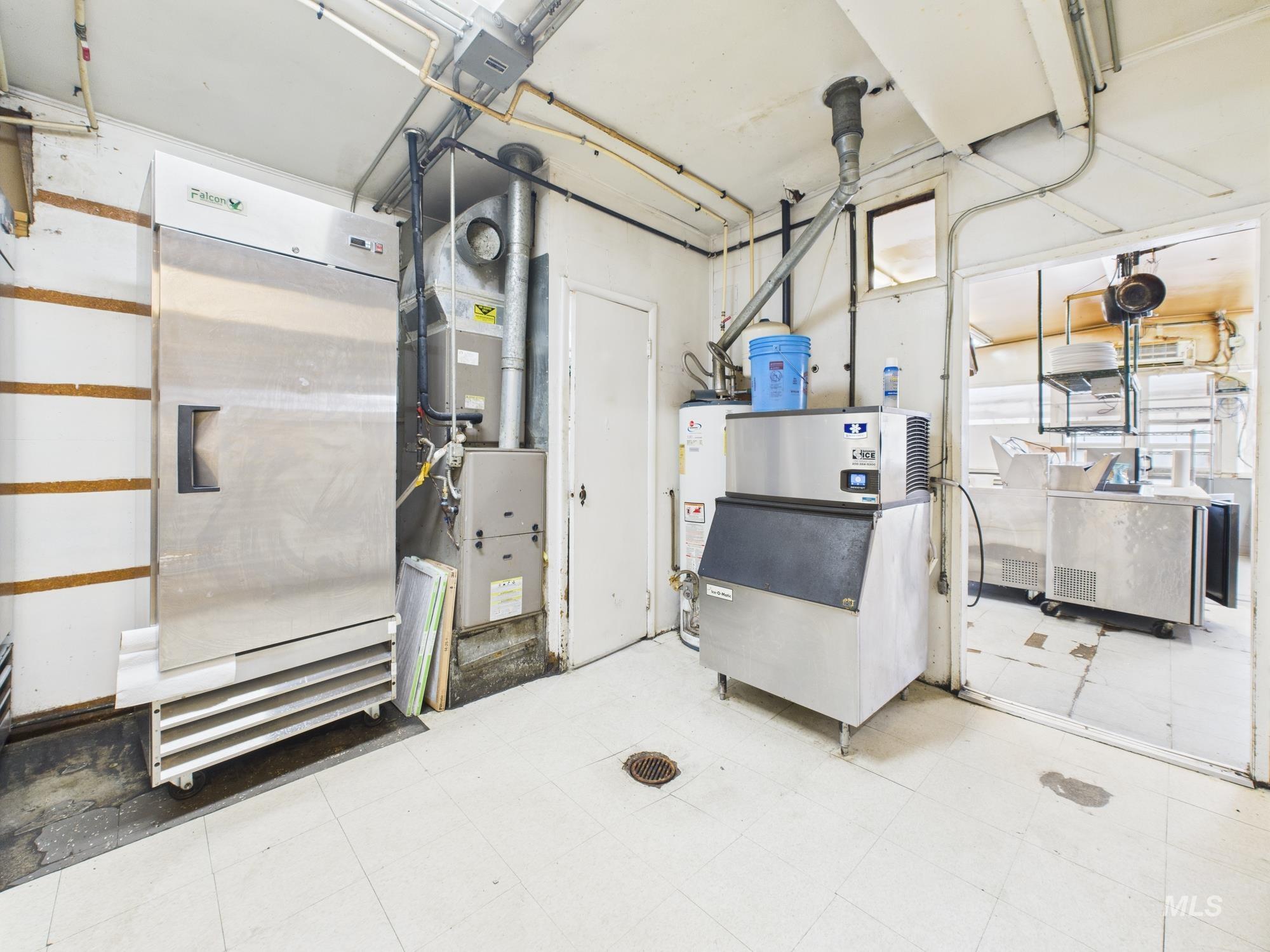 Miscellaneous room featuring heating unit and gas water heater