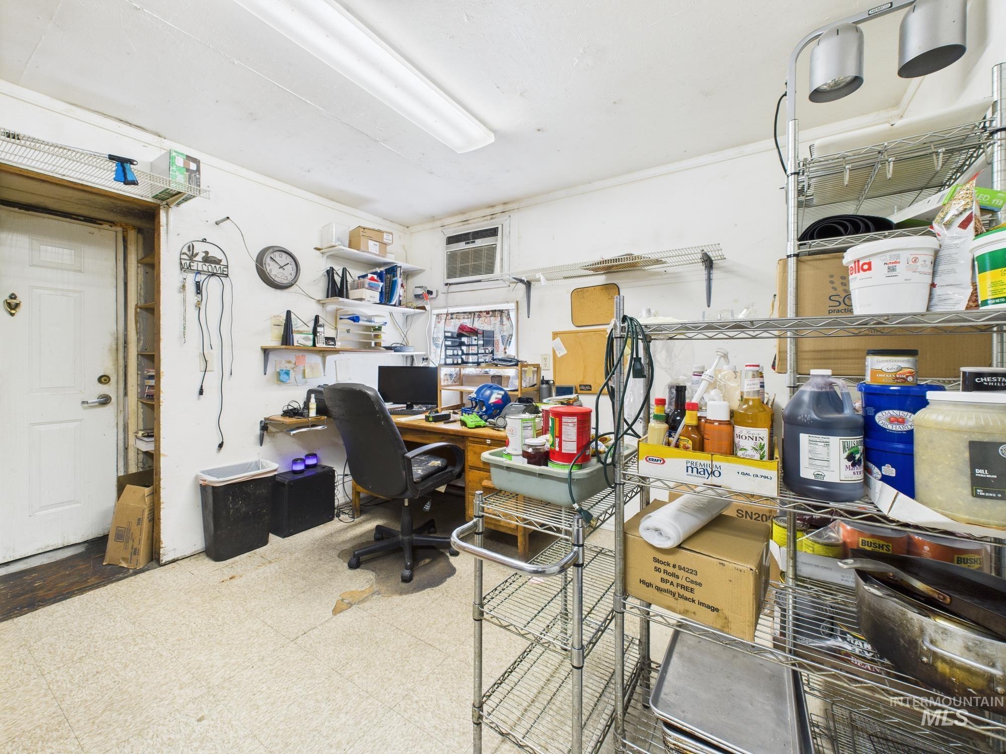 Home office featuring tile patterned floors and a wall mounted AC