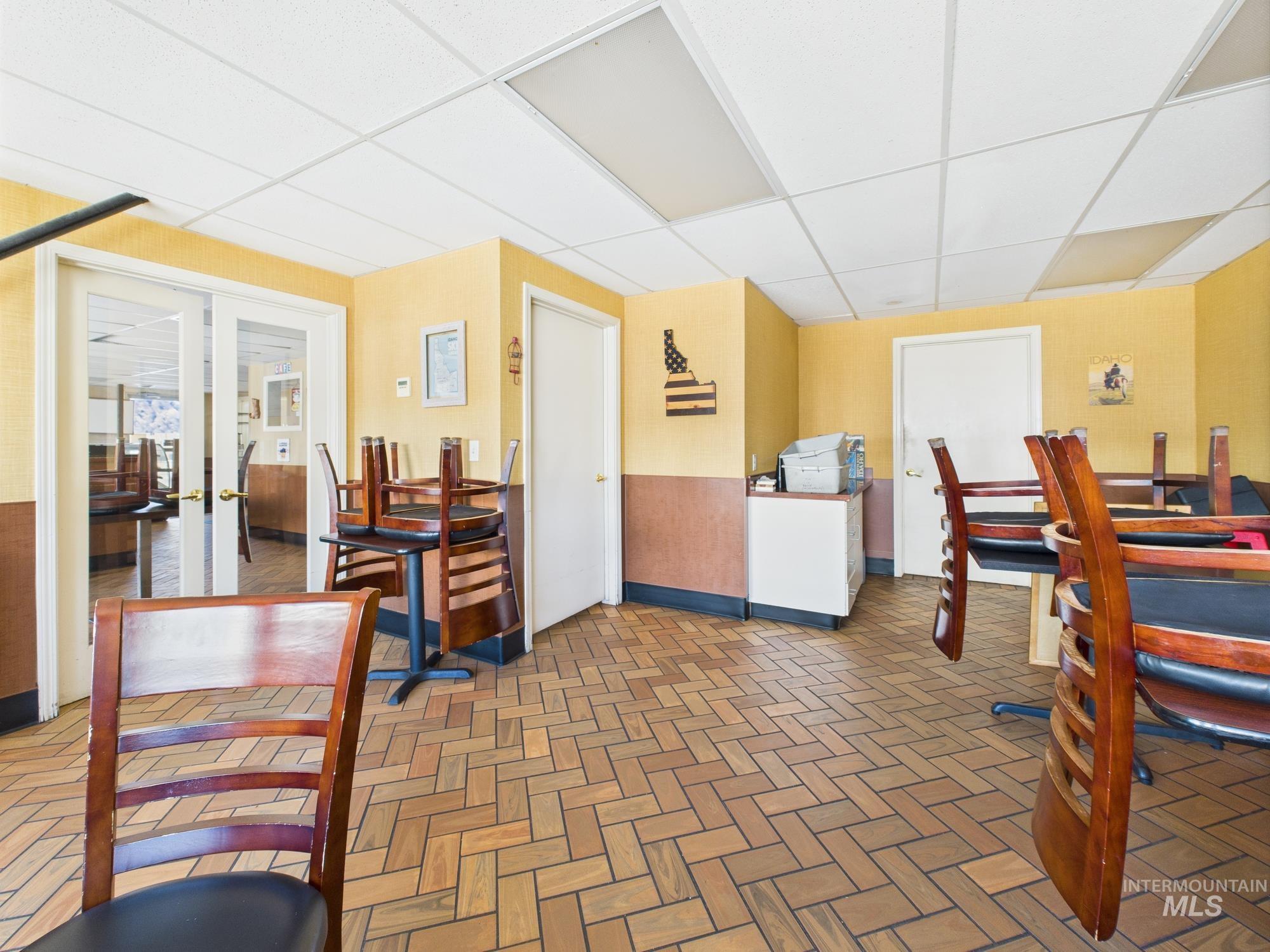 Dining room featuring a drop ceiling and french doors