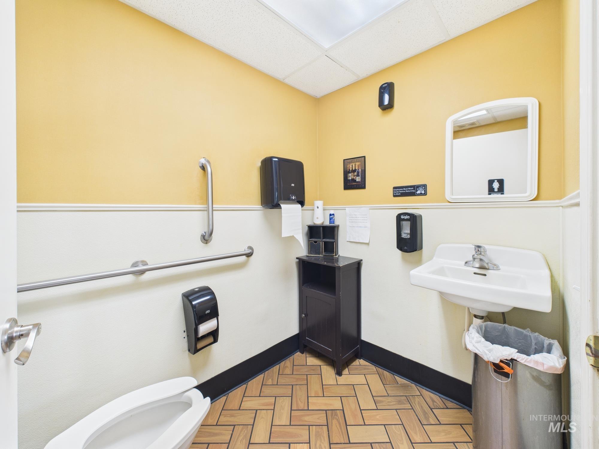 Bathroom with toilet and a drop ceiling