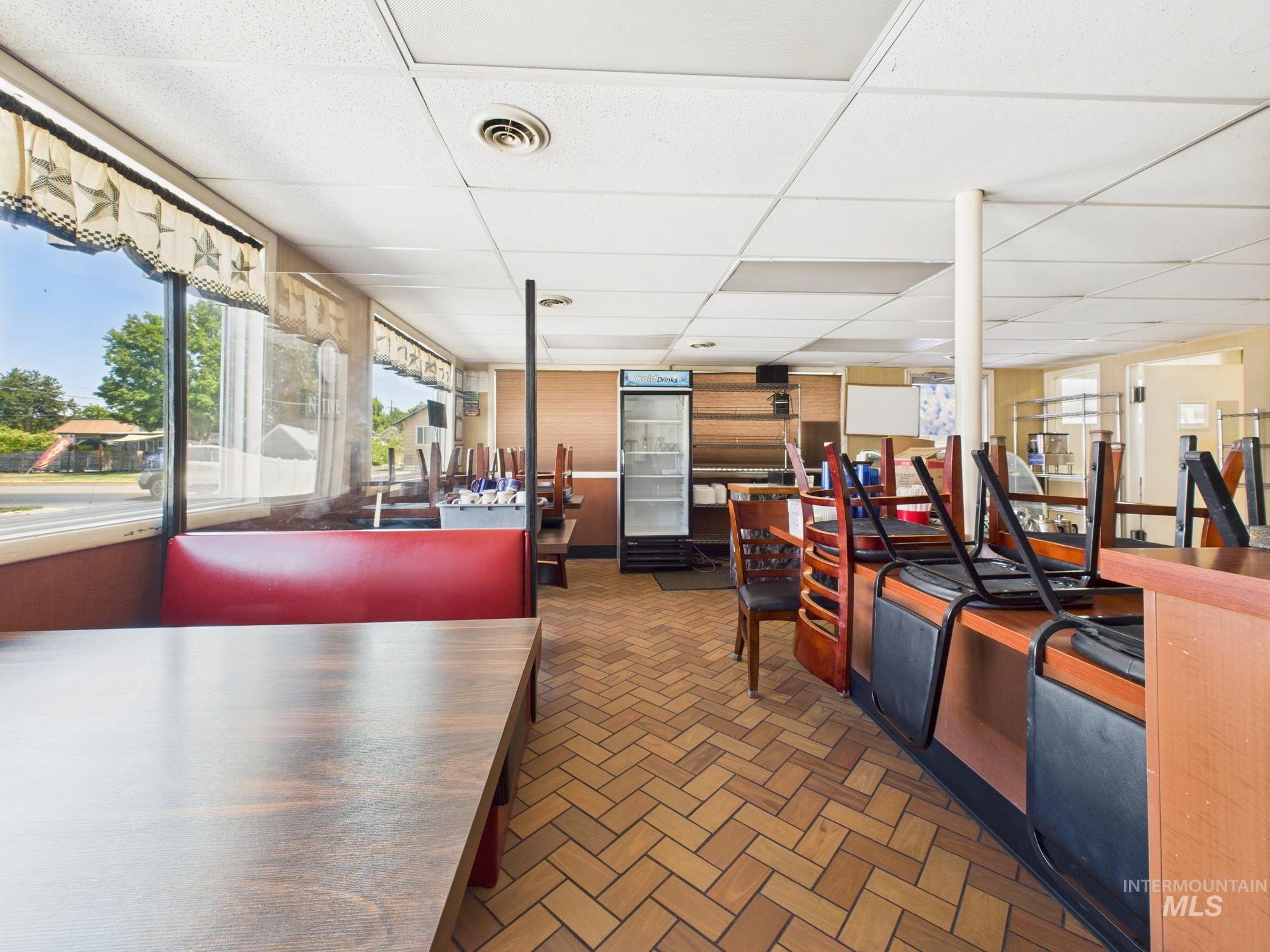 Misc room featuring a drop ceiling and brick patterned floors