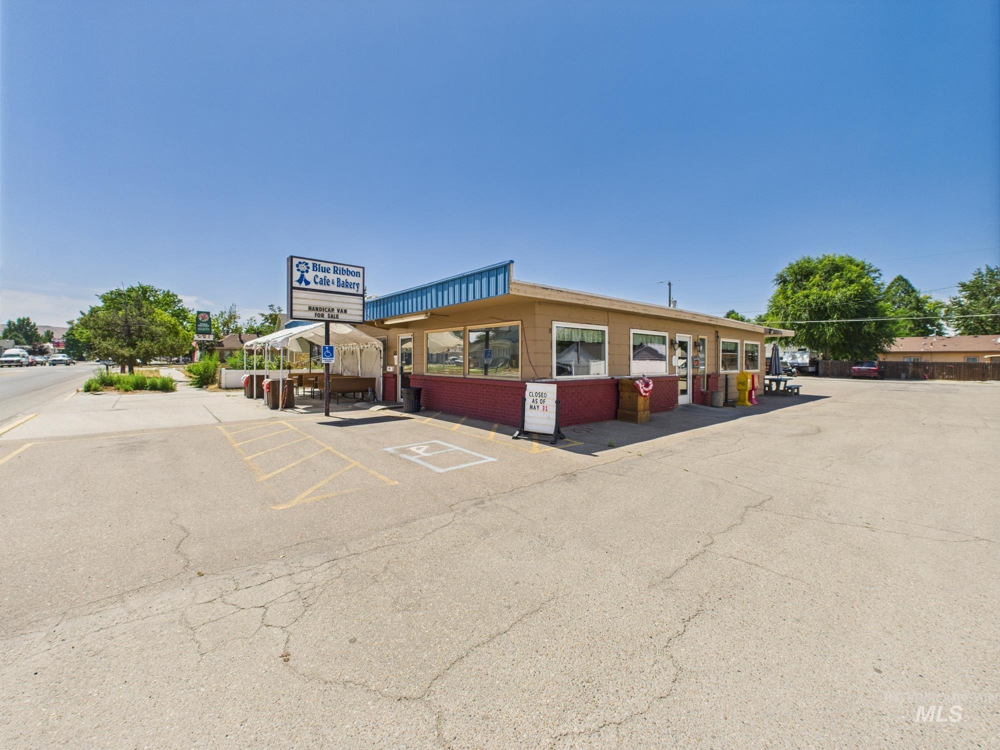 View of commercial property with uncovered parking