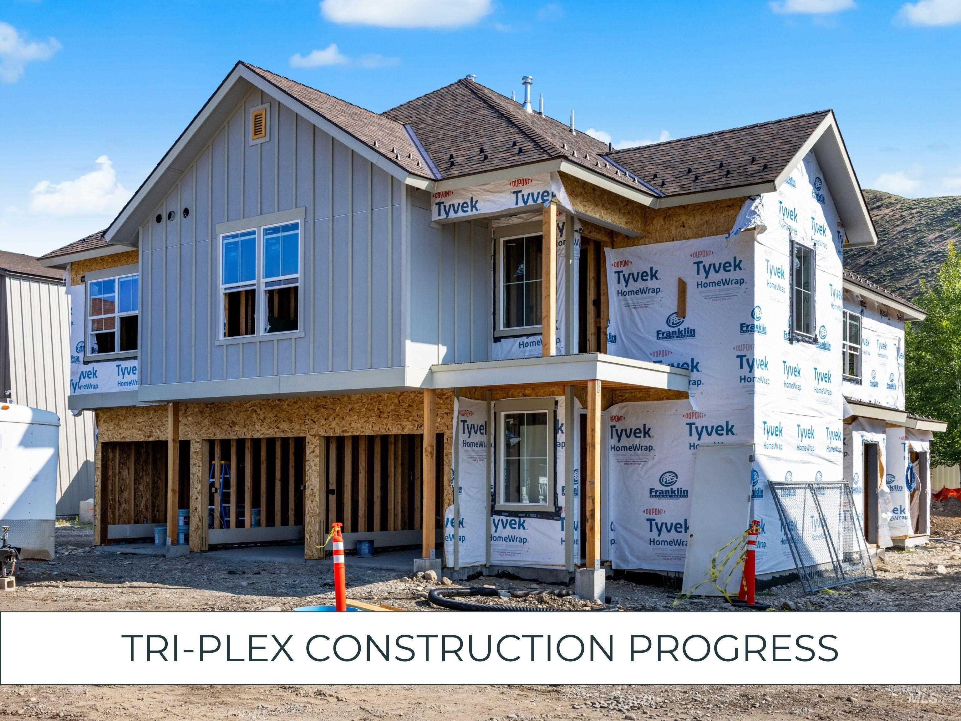 Property in mid-construction featuring board and batten siding and roof with shingles