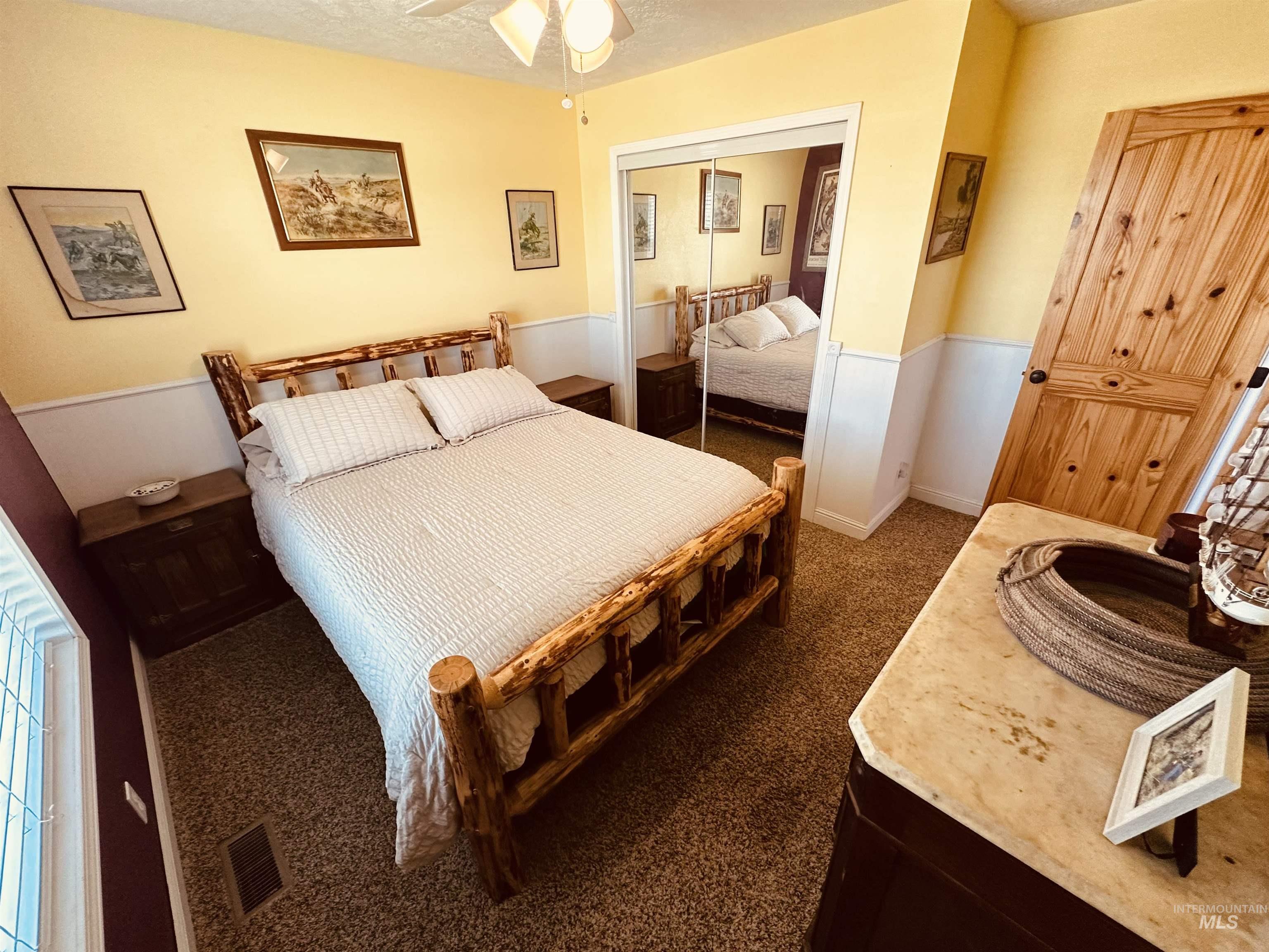 Bedroom with carpet floors, a textured ceiling, and a closet