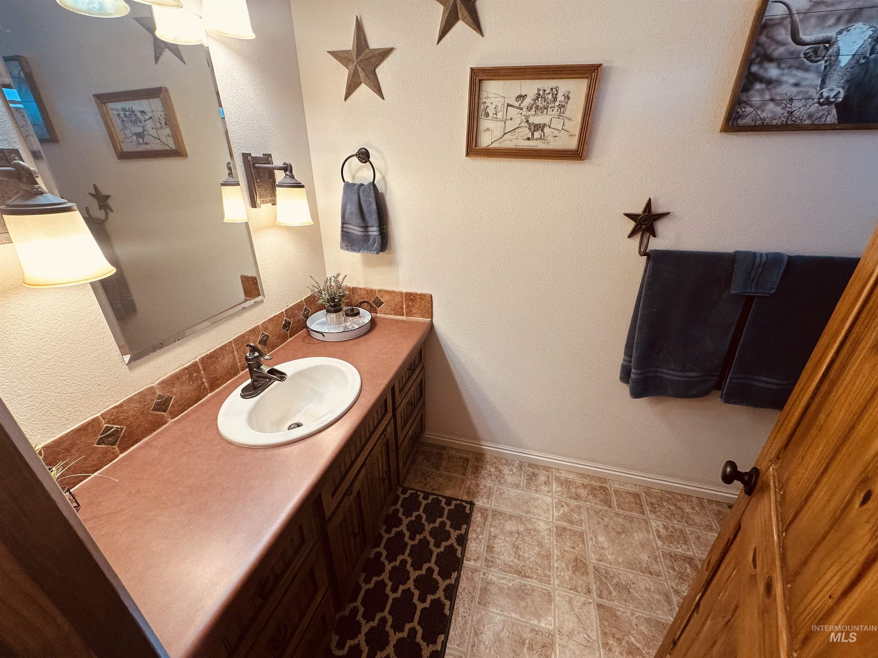 Bathroom with vanity and baseboards