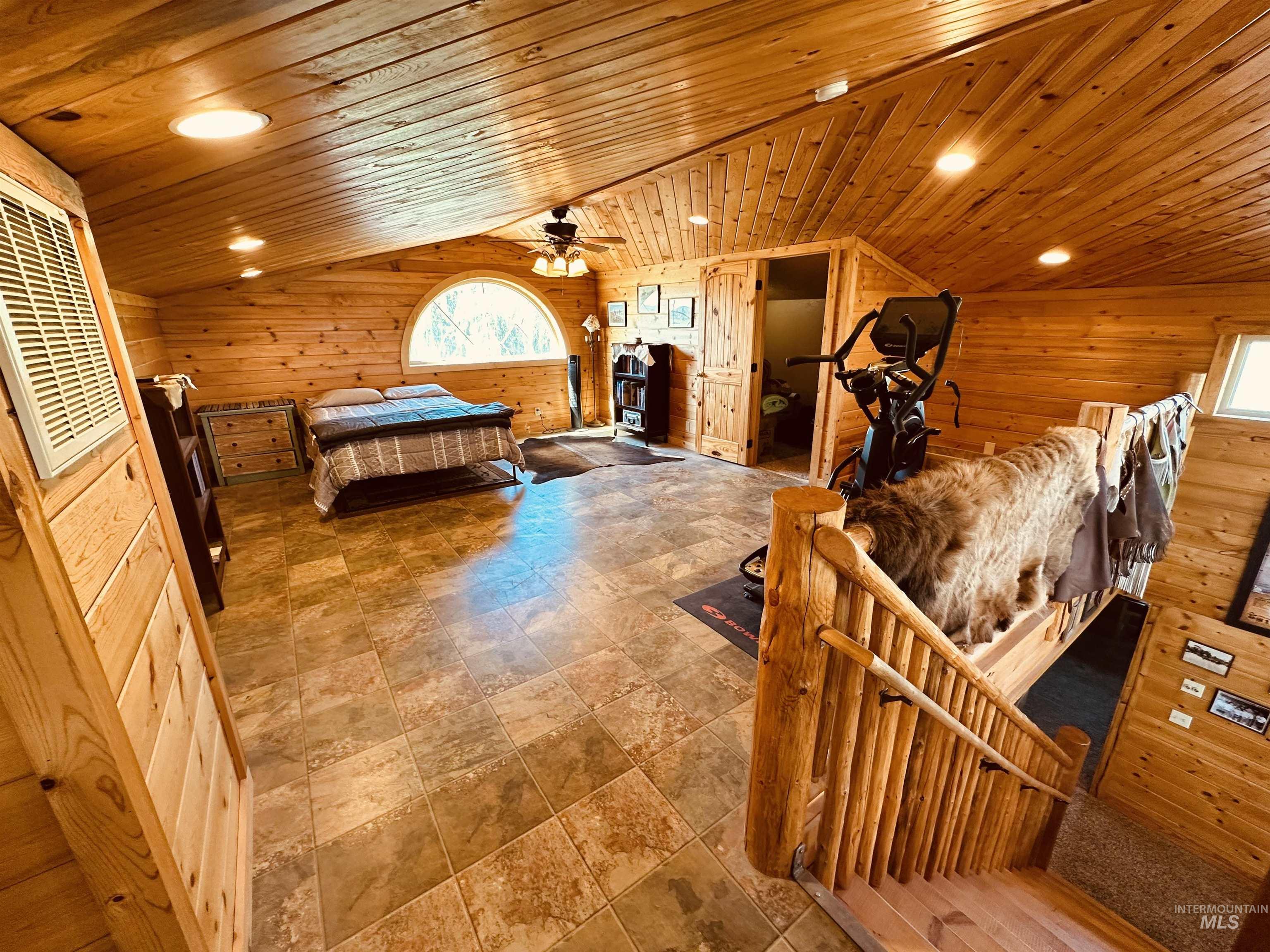 Up stairs rec room with wooden ceiling, wood walls, recessed lighting, and lofted ceiling