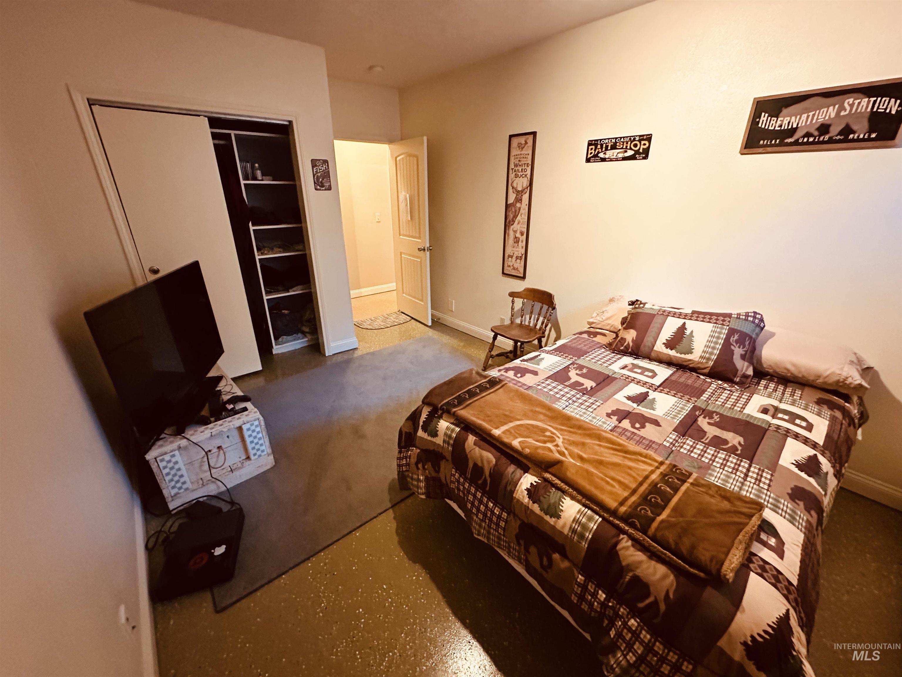 Down stairs Bedroom featuring baseboards and a closet