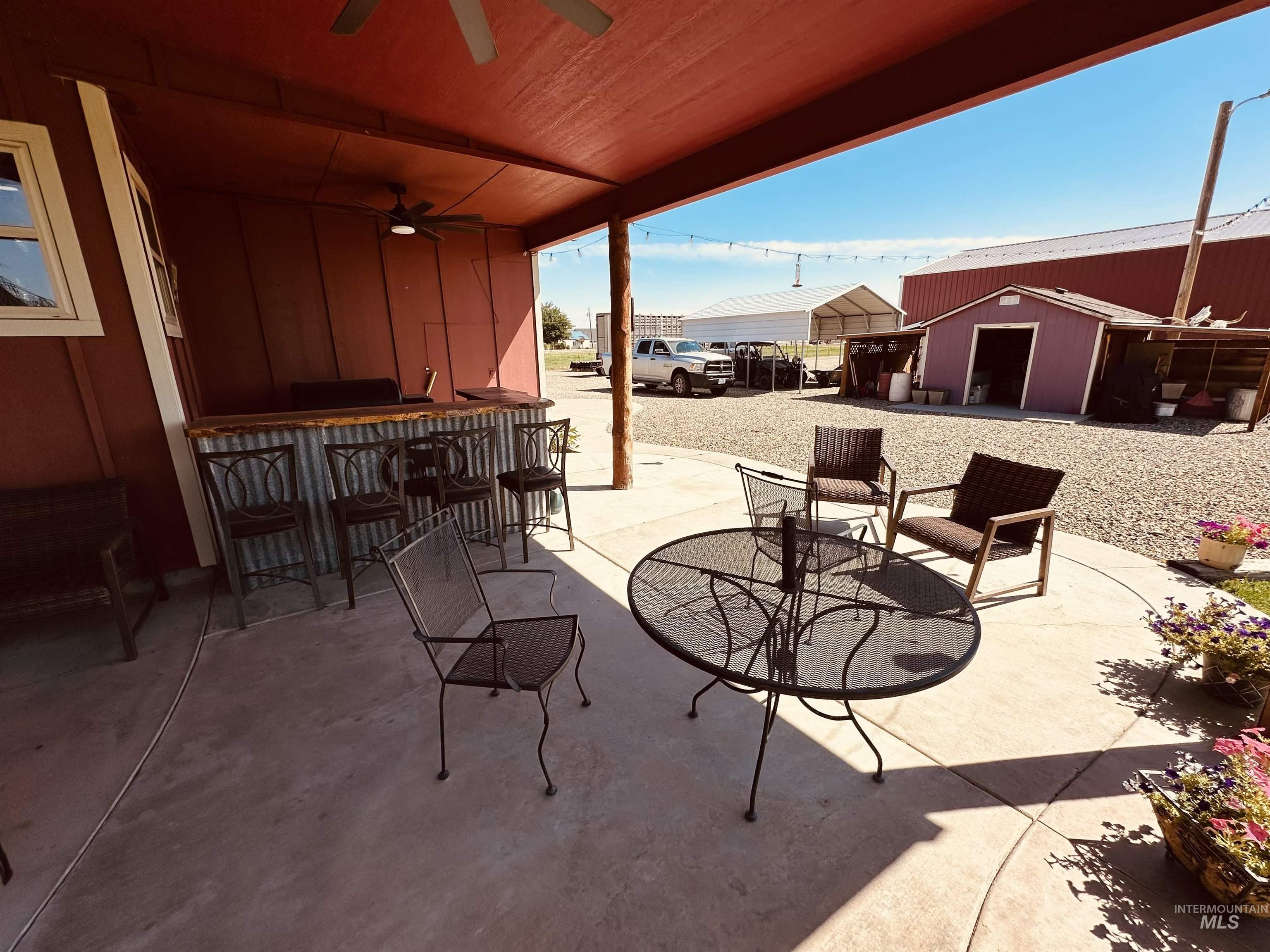 View of patio with a ceiling fan and an outdoor structure