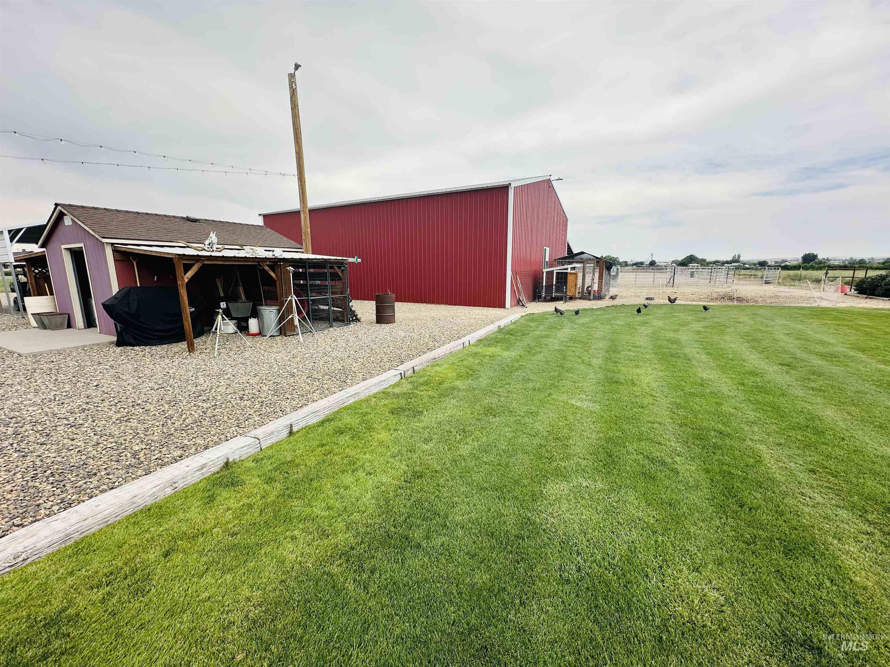 View of yard featuring a pole building and an outdoor structure