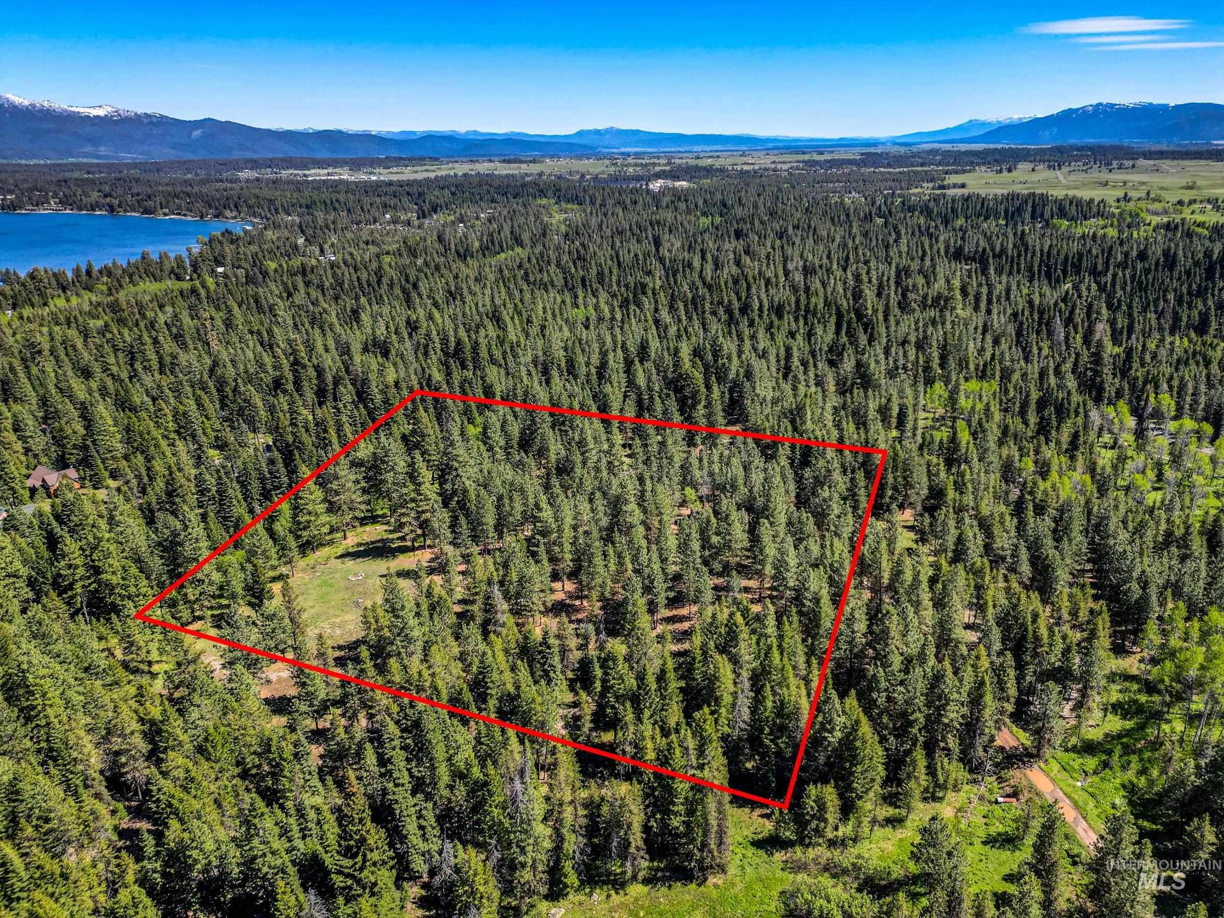 Aerial view of property's location featuring mountains and property parcel outlined