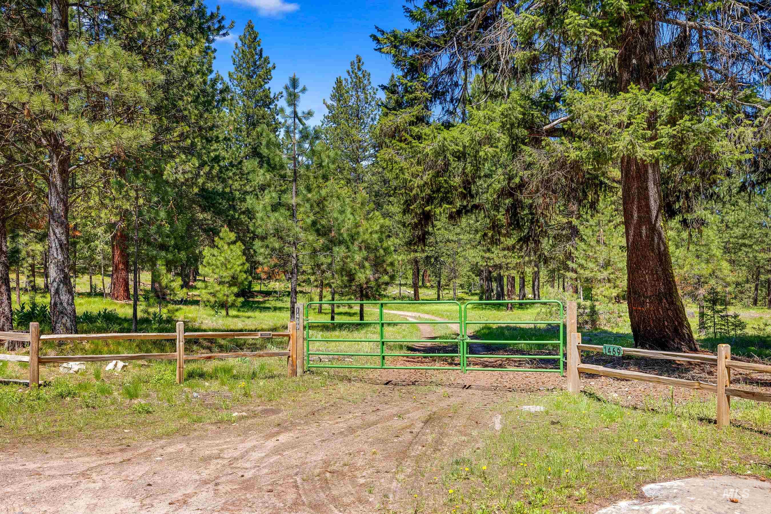 View of dirt / gravel road with a gate