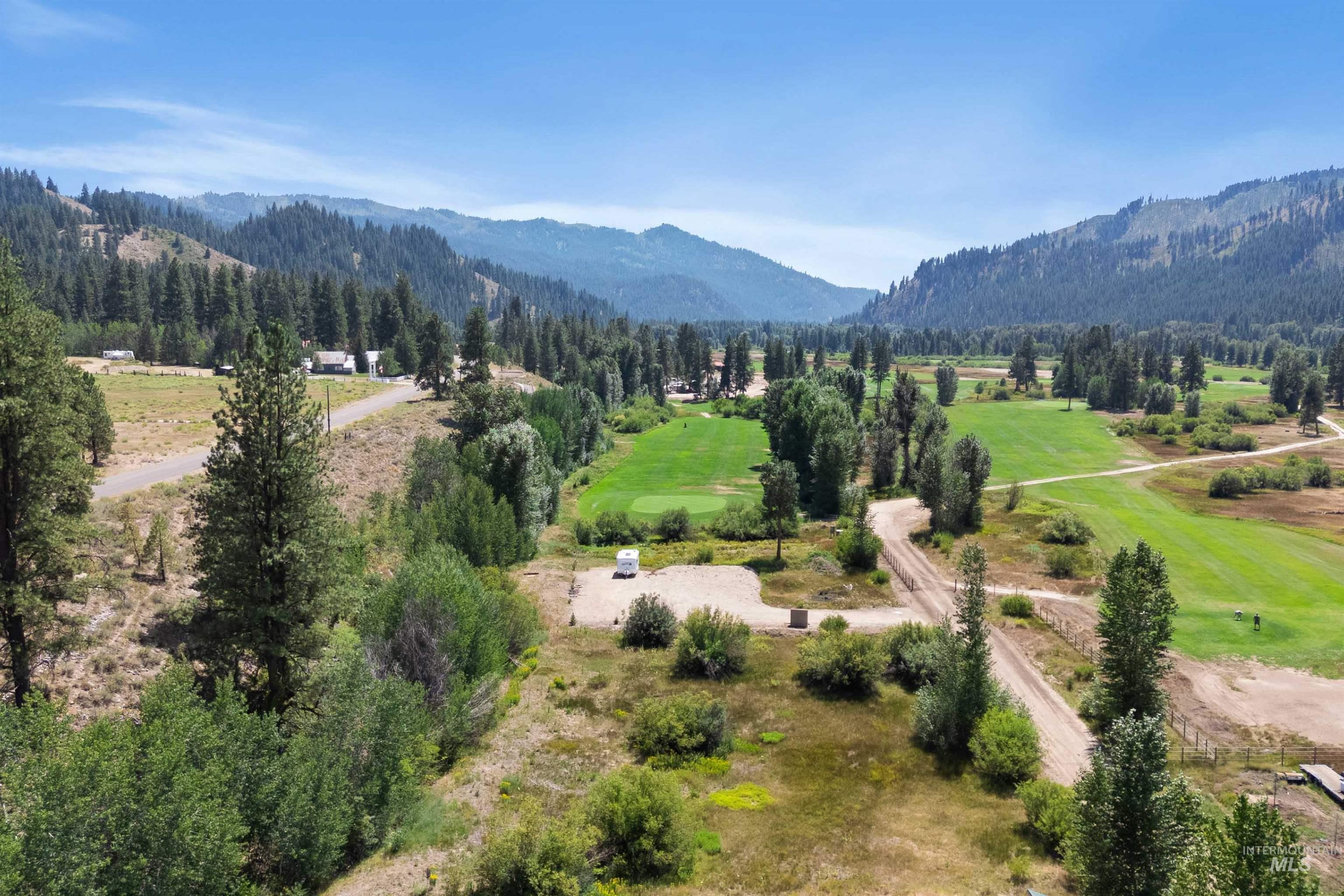 Bird's eye view of a mountainous background and a golf club