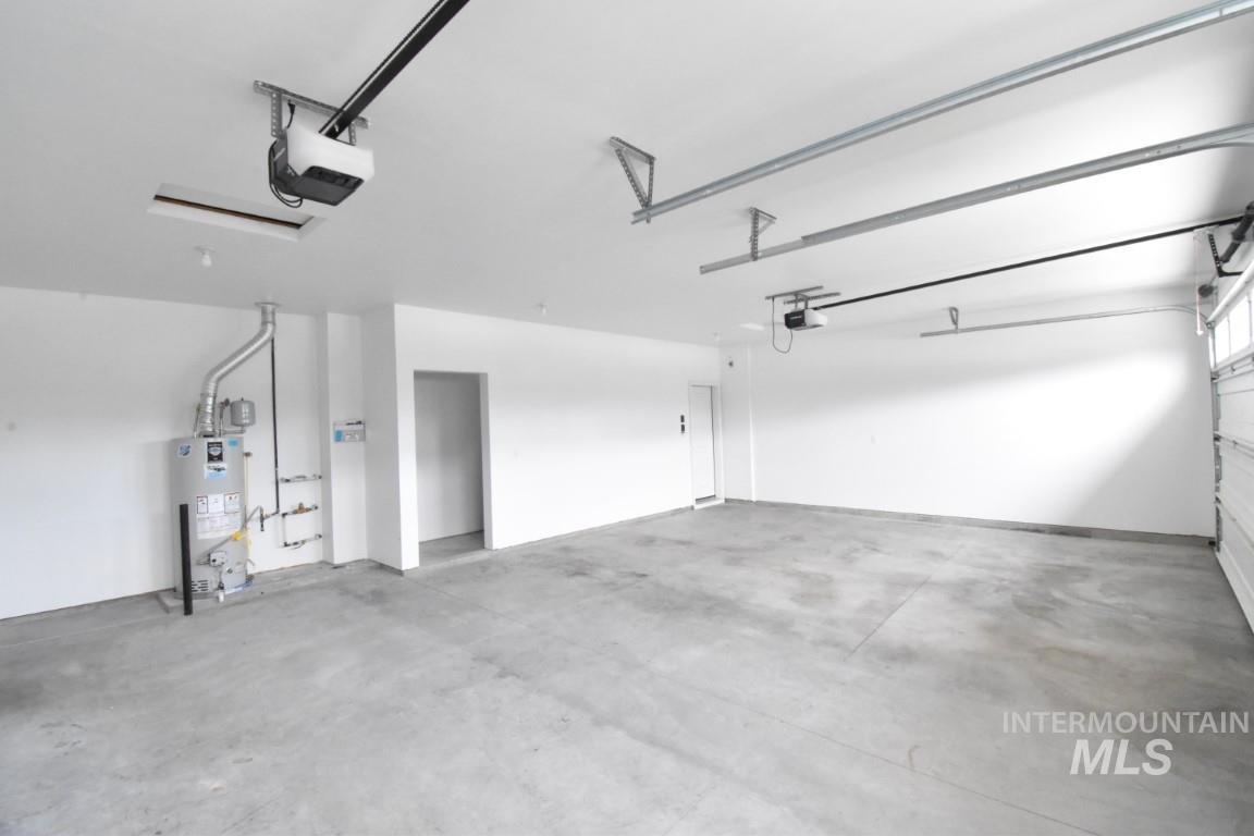 Garage with water heater and a garage door opener