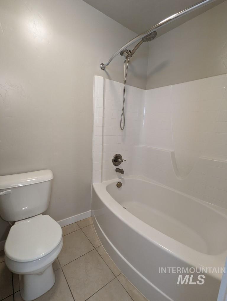 Full bathroom featuring tub / shower combination and tile patterned floors