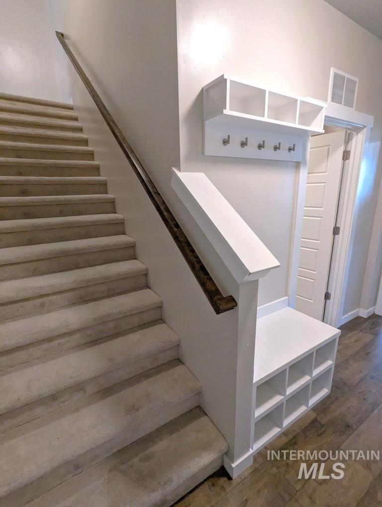 Stairway featuring wood finished floors and baseboards