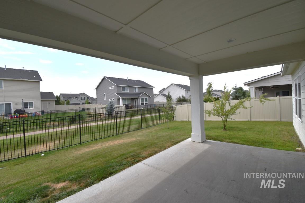 Fenced backyard with a residential view and a patio
