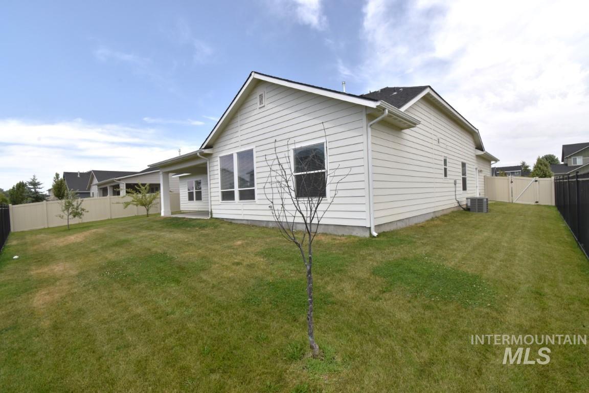 Rear view of property featuring a fenced backyard and a gate