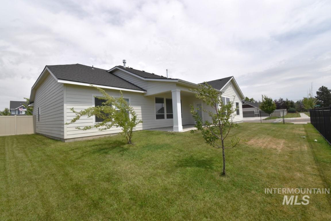 Back of property with roof with shingles