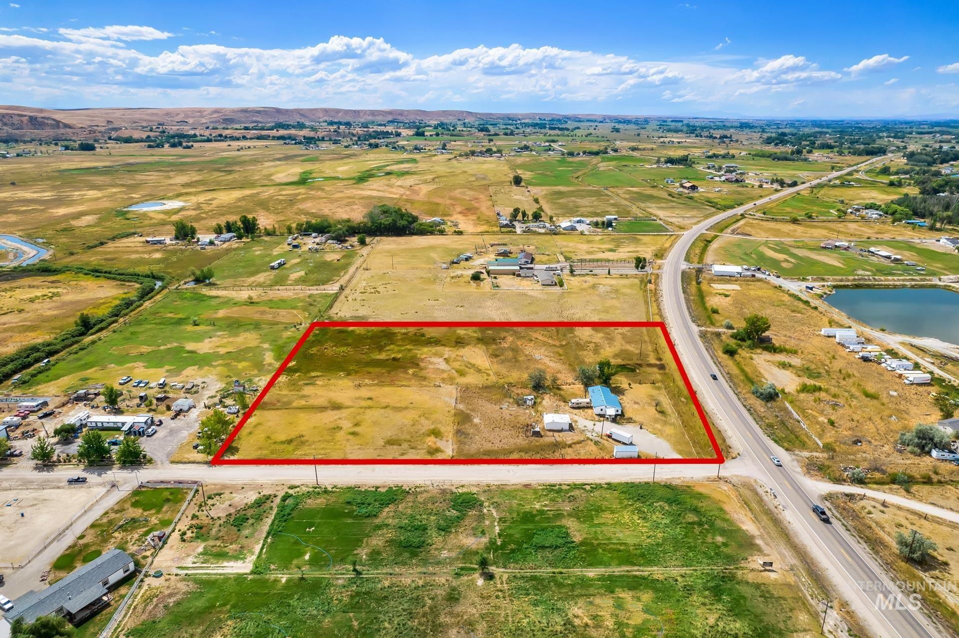 Overview of rural landscape featuring property boundaries highlighted and a large body of water