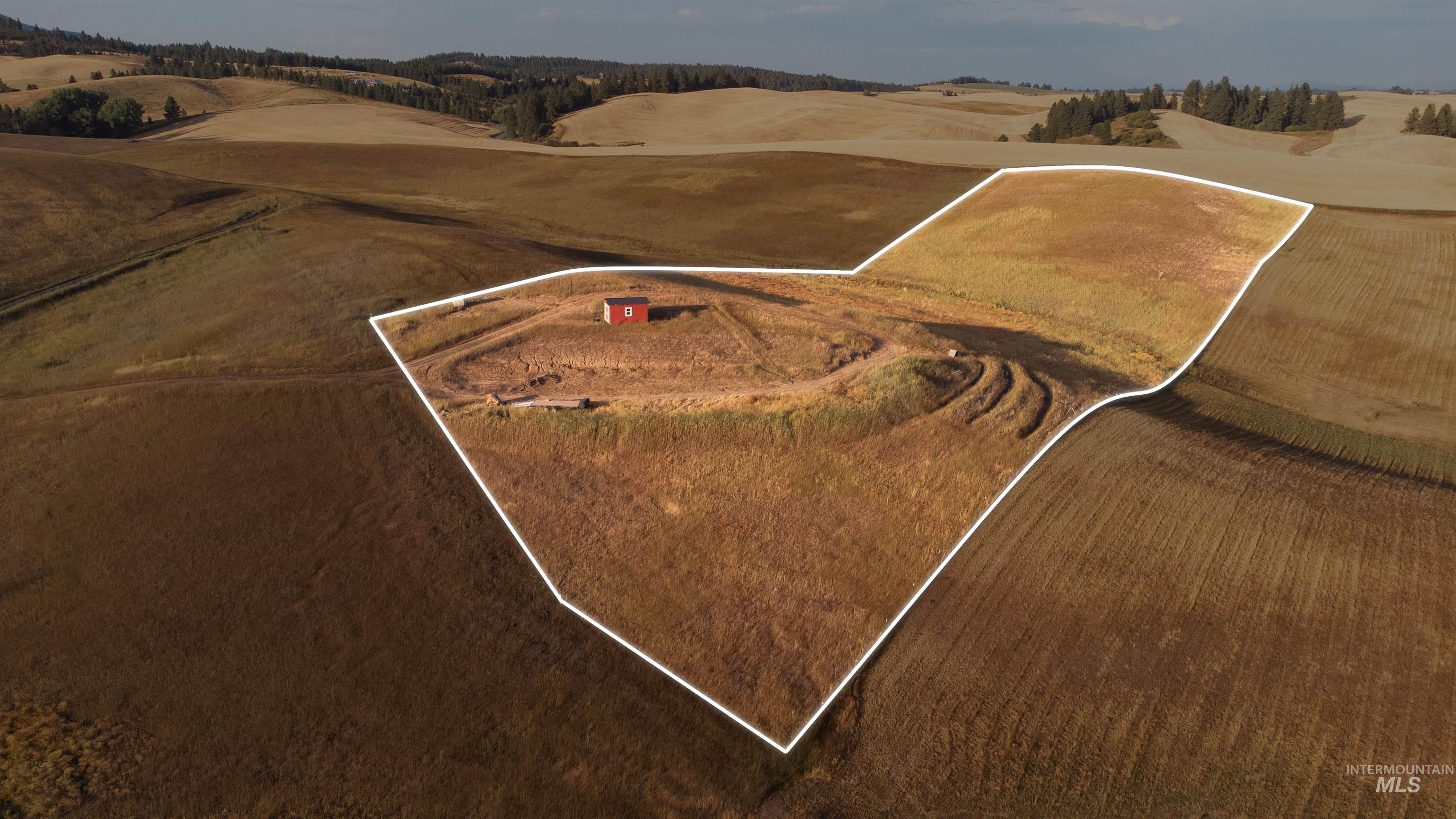 Aerial overview of property's location from SW Corner featuring property parcel outlined.