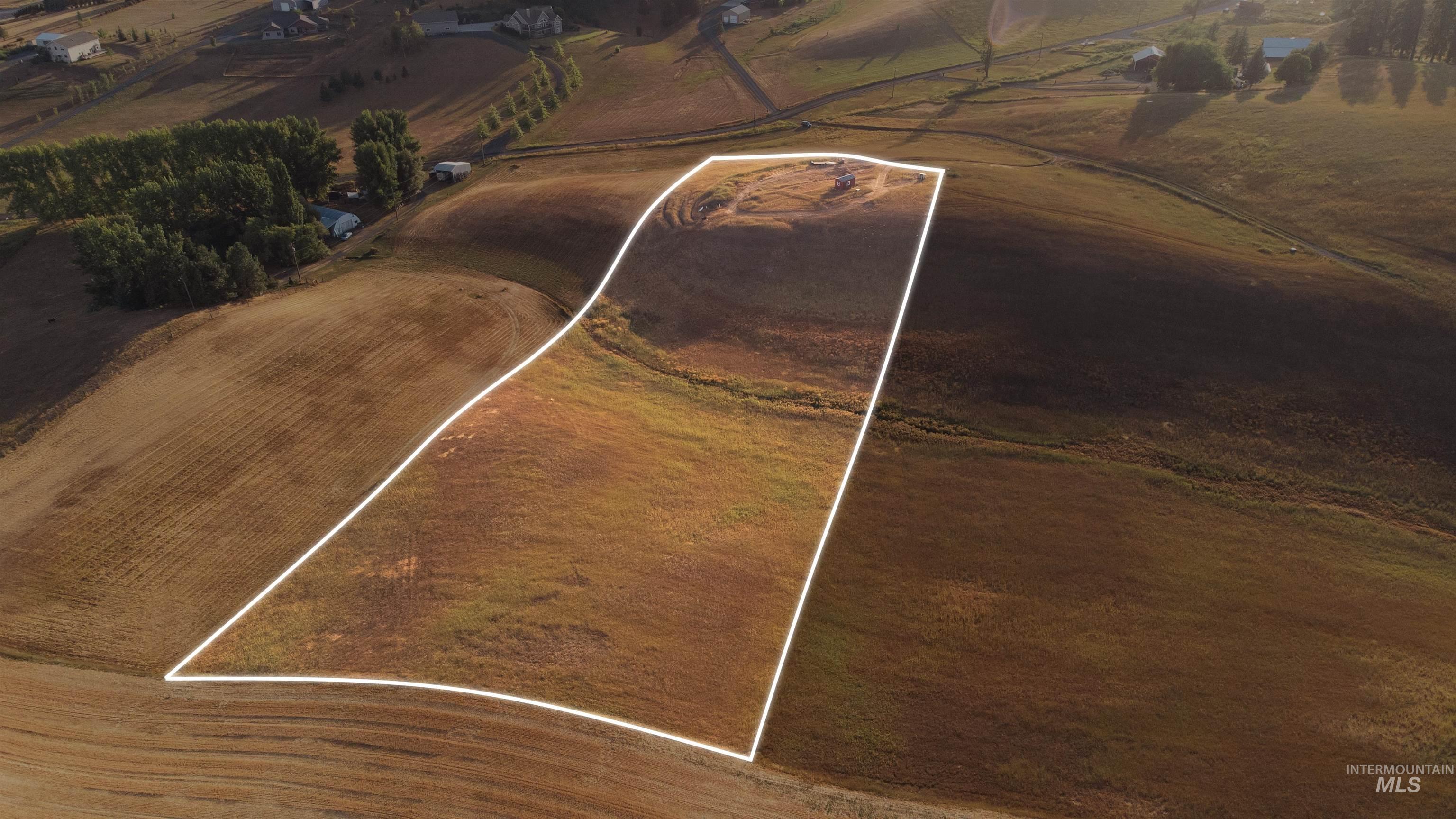 Aerial overview of property's location from NE Corner featuring property parcel outlined.