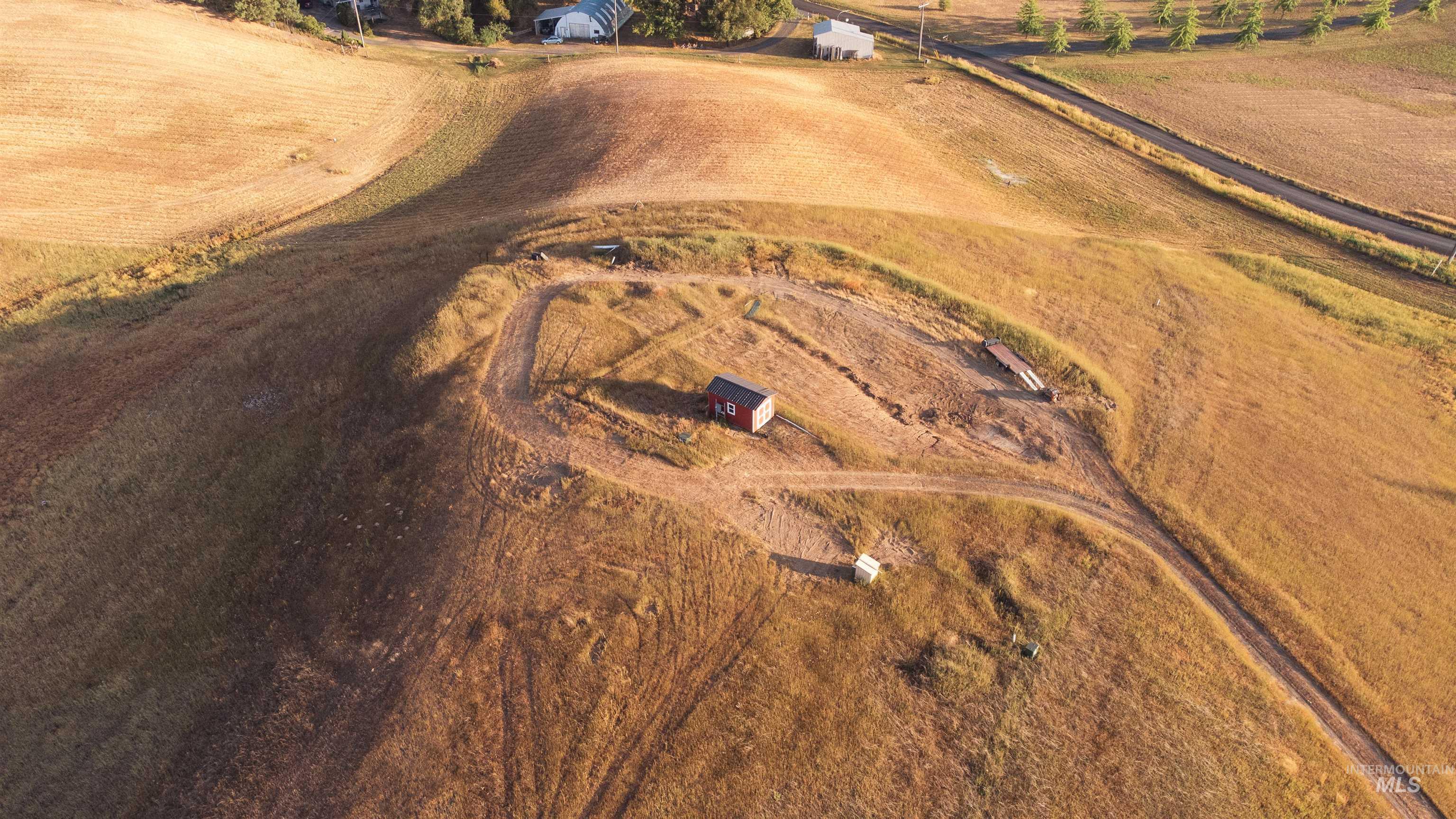 Aerial view of property and surrounding area featuring rural landscape