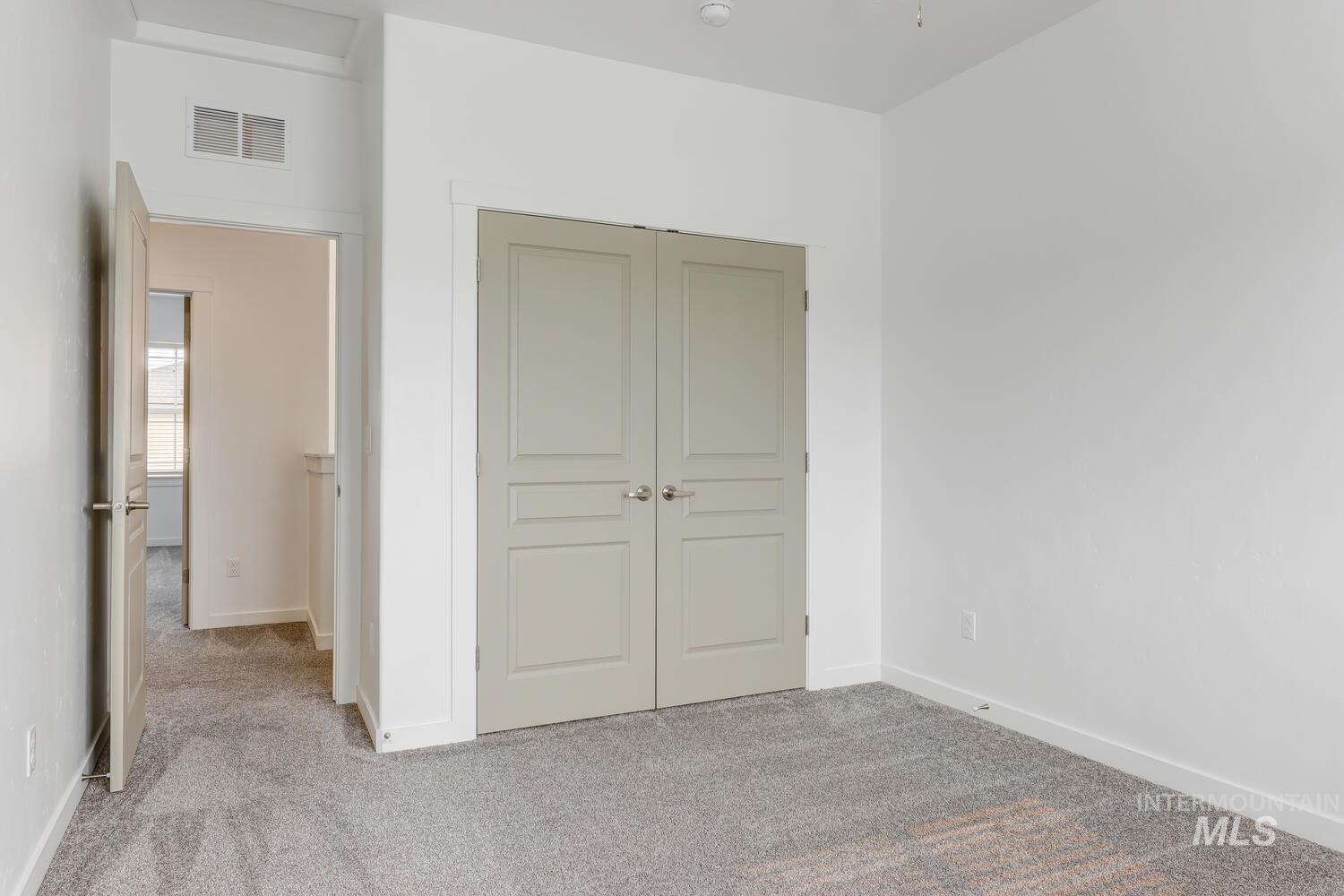 Unfurnished bedroom featuring carpet floors and a closet