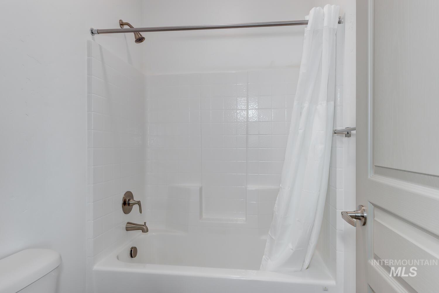 Full bathroom with shower / bath combination with curtain