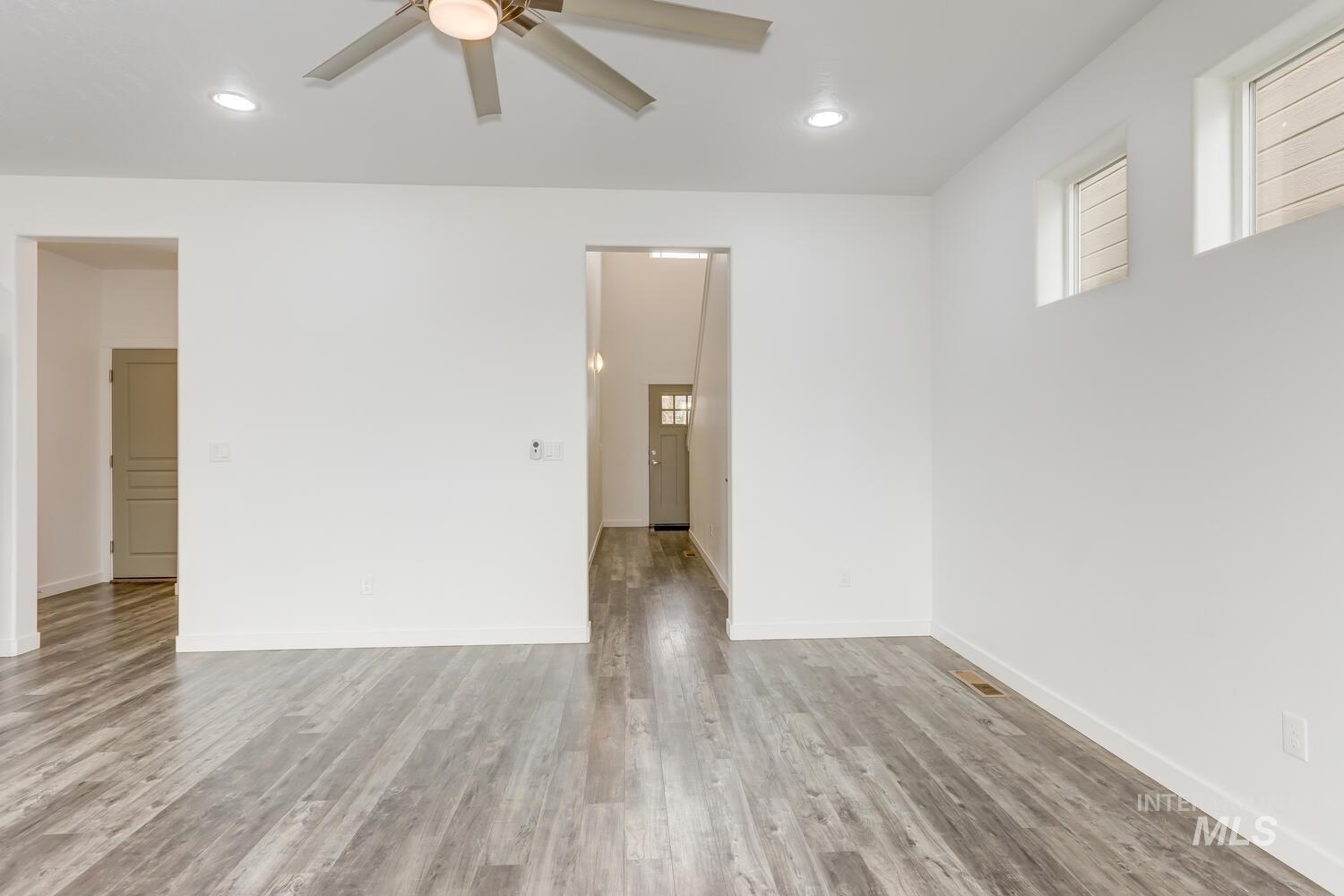 Unfurnished room with recessed lighting, a ceiling fan, plenty of natural light, and wood finished floors