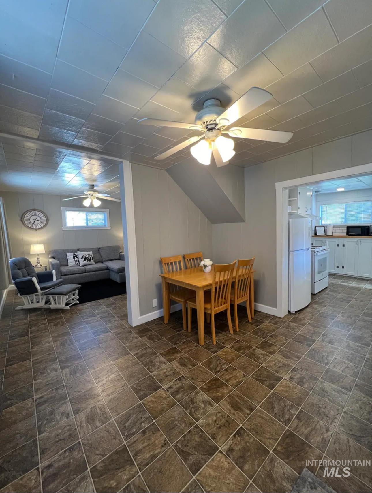 2nd home / AirBNB - Dining room with a ceiling fan and stone finish flooring