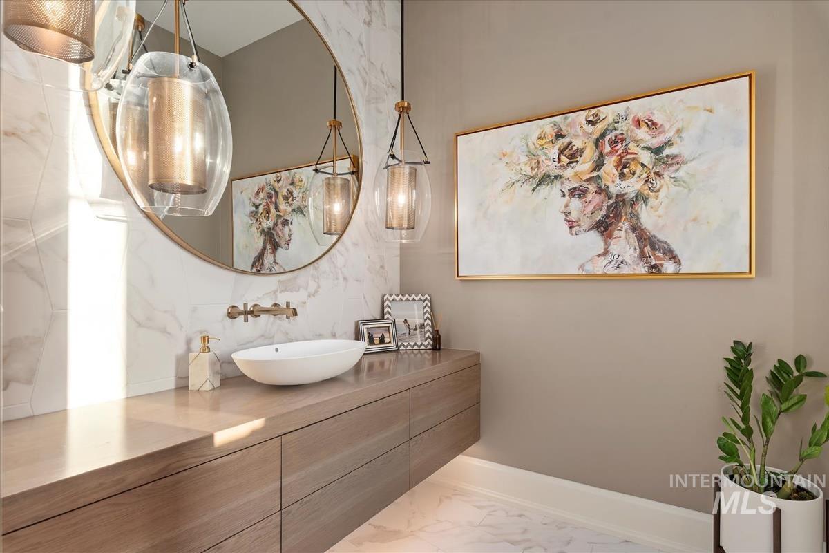 Bathroom featuring marble look tile flooring and vanity