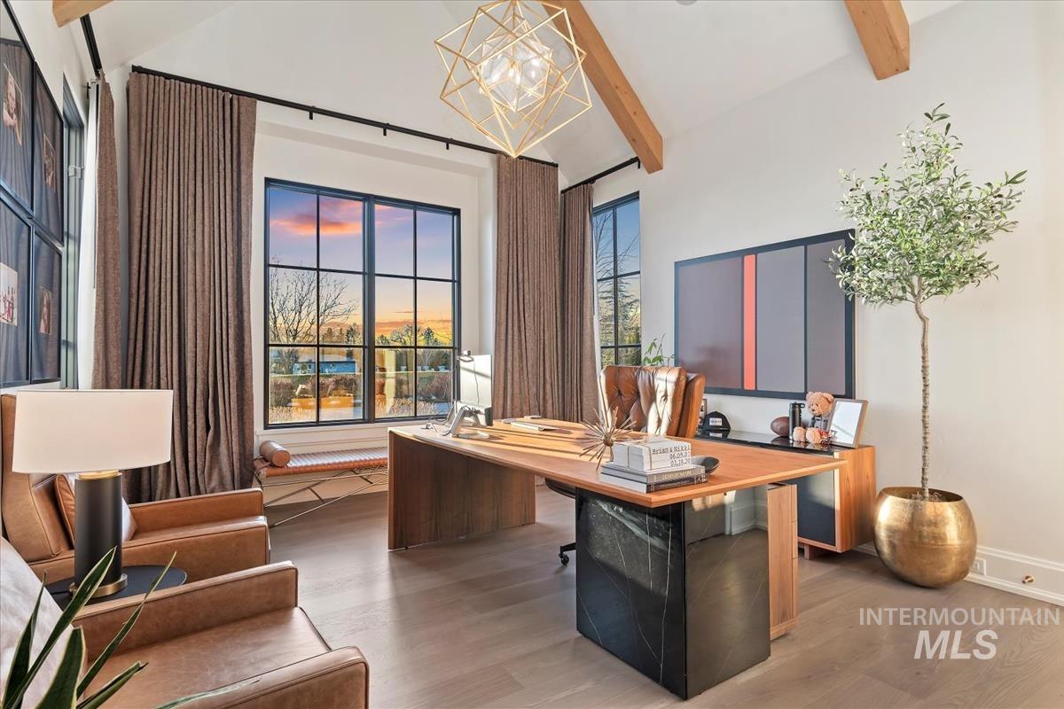 Office space with wood finished floors and a chandelier