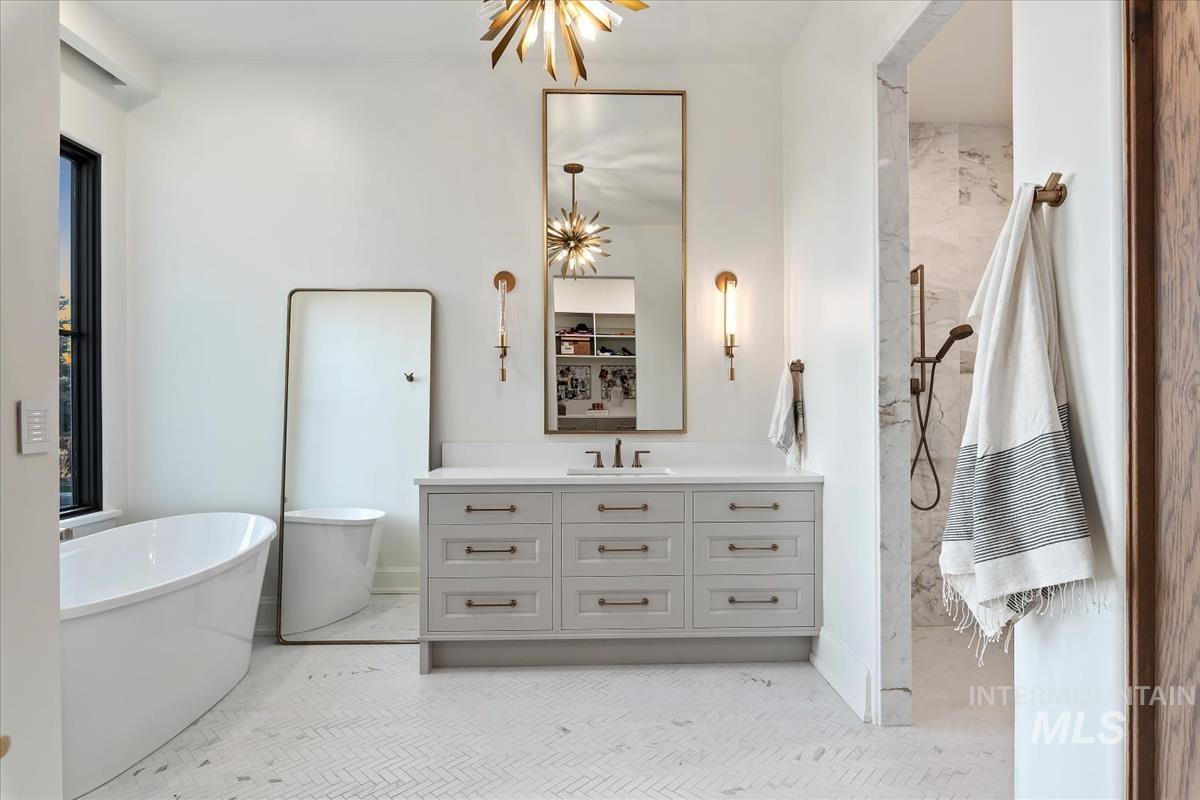 Full bathroom with vanity, a freestanding bath, and a shower