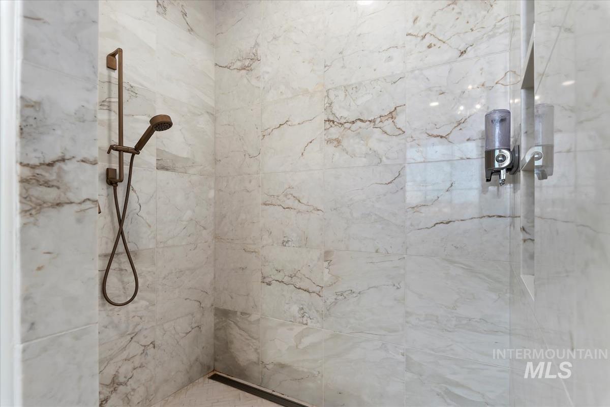 Bathroom featuring a marble finish shower