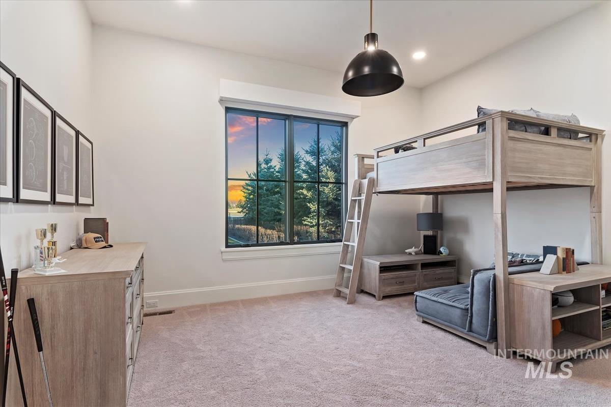 Carpeted bedroom with baseboards and recessed lighting