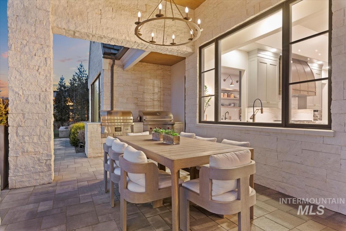 Dining room featuring a chandelier and stone tile floors