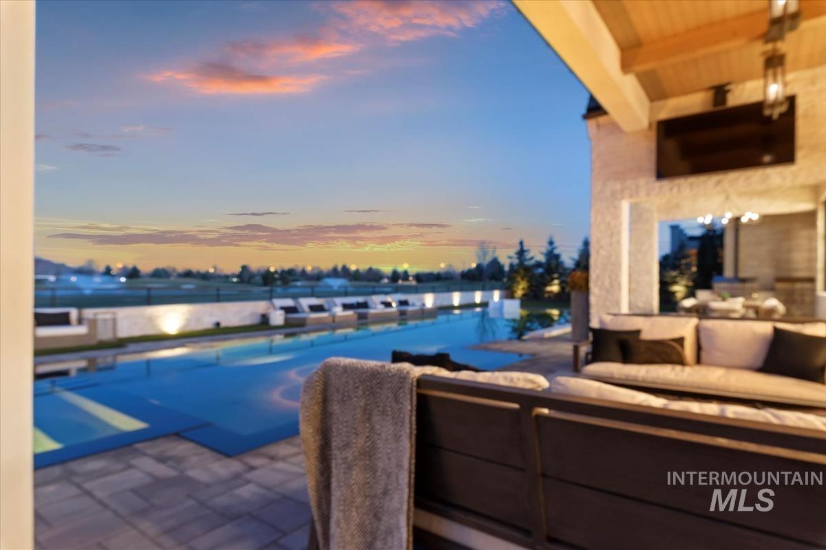 View of pool featuring a patio, outdoor lounge area, and a pool with connected hot tub