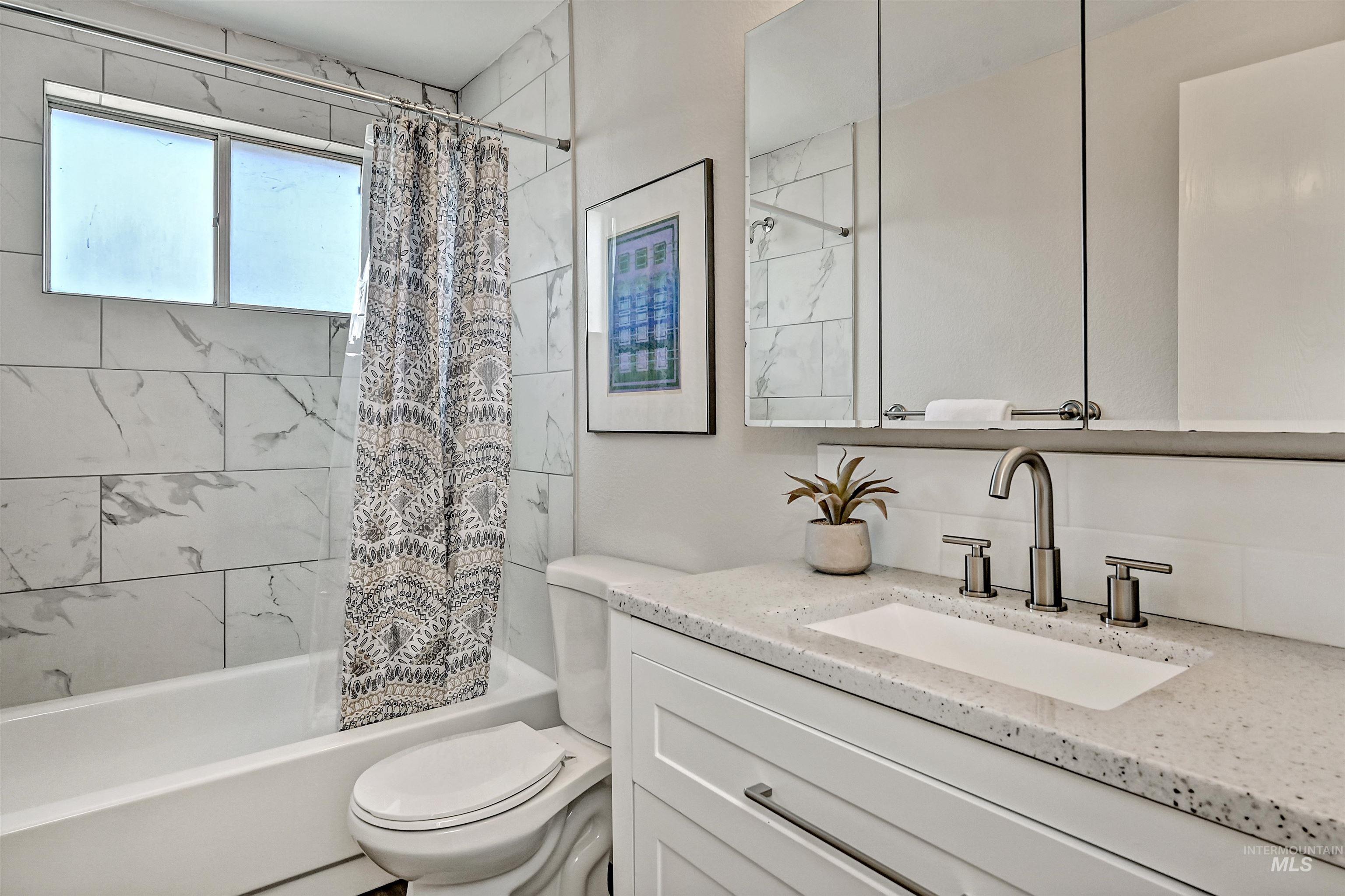 Unit A: Bathroom 2 with shower / bath combo and vanity